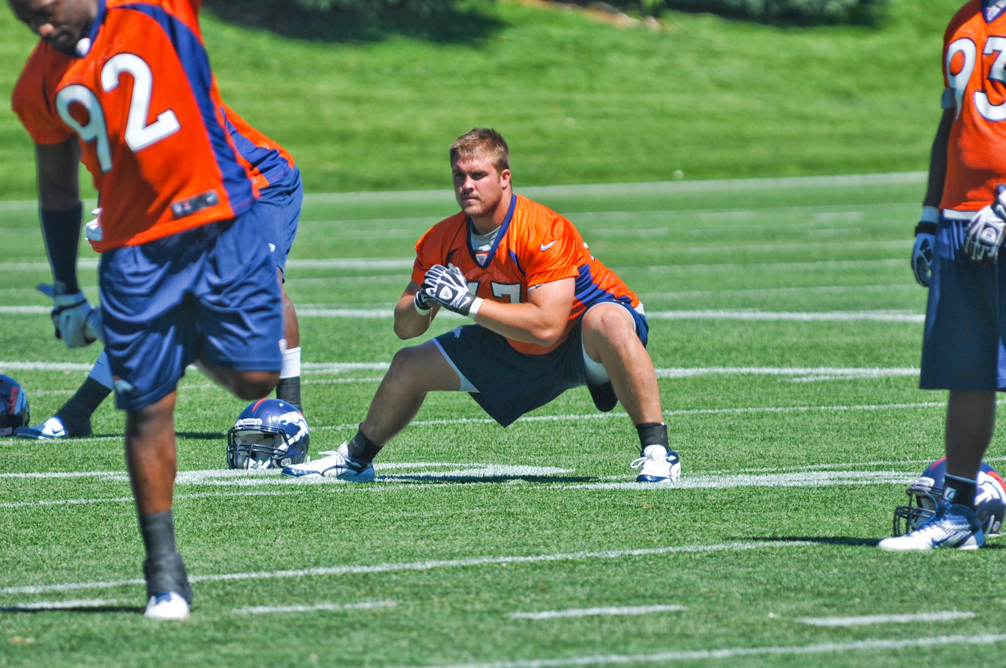 ENGLEWOOD, Colo. – Benjamin Garland stretches during a Denver Broncos mini-camp session June 13, 2012. Garland graduated with the Air Force Academy Class of 2010 and began his Air Force career as a strength and conditioning coach for the academy. He is currently assigned to the 140 Wing Public Affairs Office, Colorado Air National Guard. (U.S. Air Force photo by Senior Airman Christopher Gross)