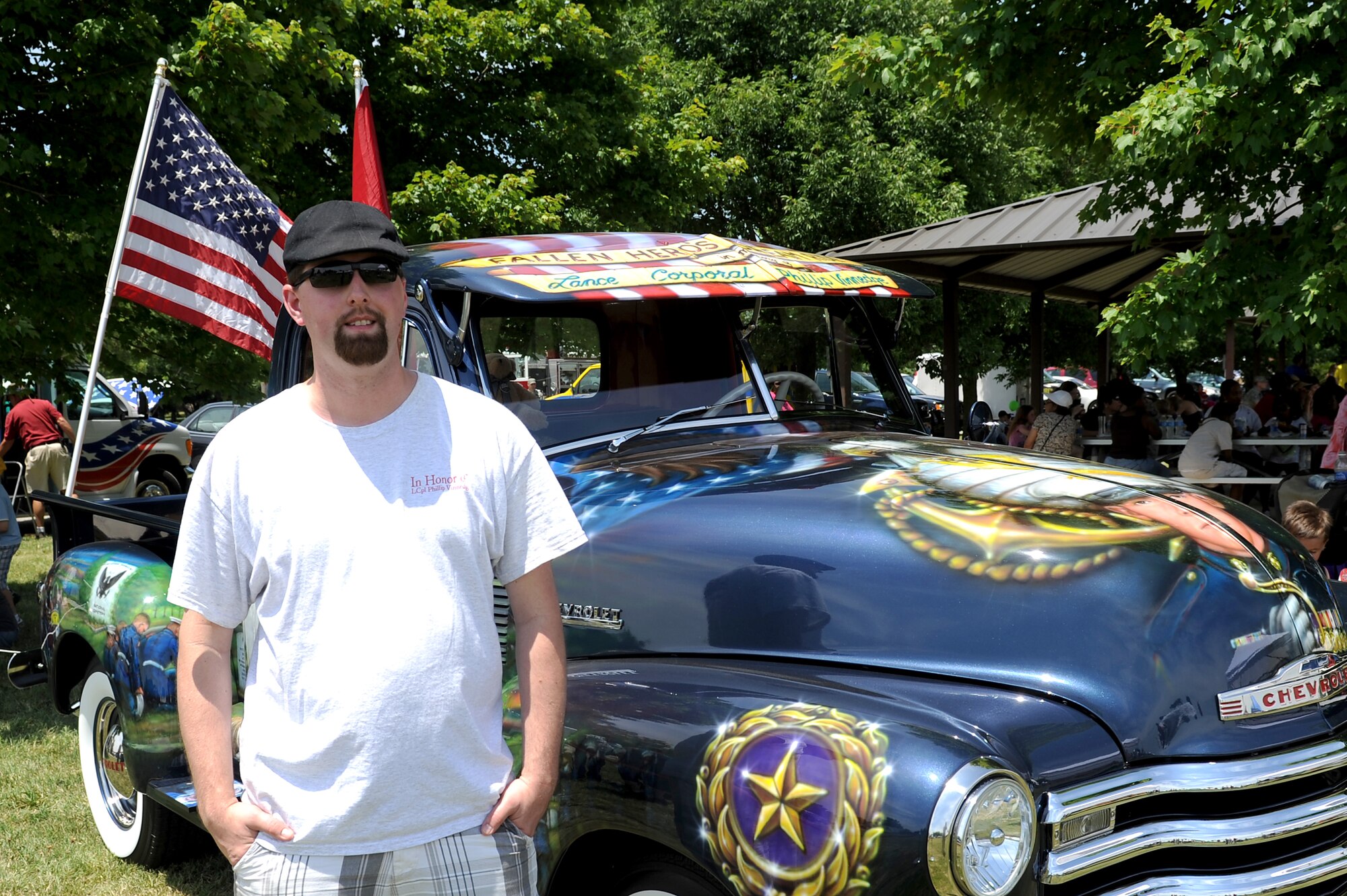 Corey Vinnedge stands in front of the truck he restored for his brother and fallen Marine Lance Cpl. Phillip Vinnedge during the Fallen Hero's Dream Ride truck is display at the base wide picnic at Scott Air Force Base, Ill. June 15 , 2012. Fallen Hero's Dream Ride was formed after the death of Lance Cpl. Phillip Vinnedge who was killied in action while serving in Afghanistan. The goal of Fallen Hero's Dream ride is to create a rolling memorial to build awareness of the sacrifices our fallen military men and women have made, and to encourage support of related not for profit organizations. (U.S. Air Force photo/2nd Lt. Korey Fratini)