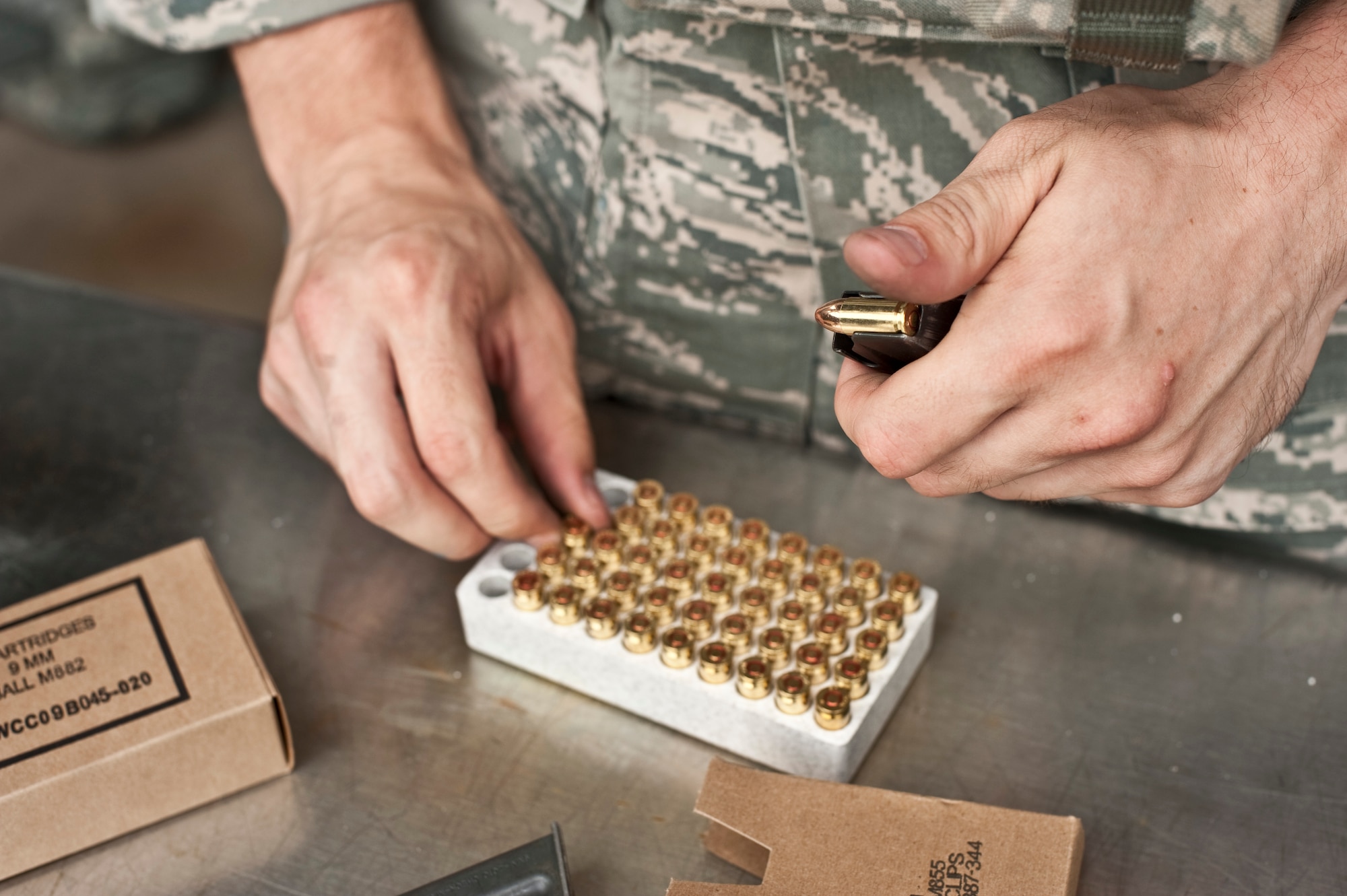 A U.S. Air Force Airman from the 1st Special Operations Security Forces Squadron loads ammunition into a magazine during the Multi-Assault Counter-Terrorism Action Capabilities course at Hurlburt Field, Fla., June 8, 2012. The MACTAC course teaches students to locate and neutralize violent assaults or terrorist attacks. (U.S. Air Force Photo/Airman 1st Class Hayden K. Hyatt)