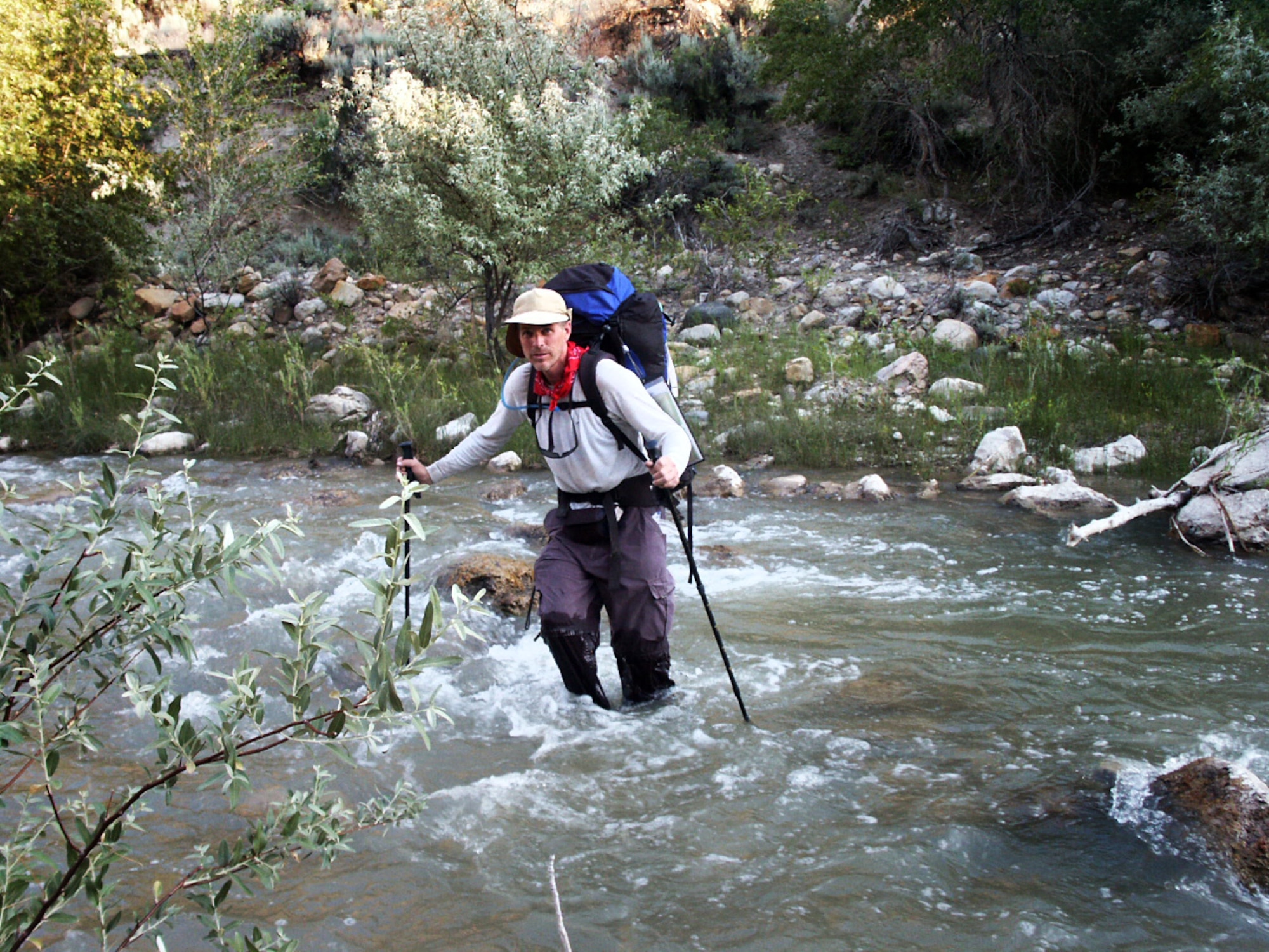 Jon Warnick crosses a river near Salina, Utah, during a walk across the state, summer of 2003.  The hike was part of a trek spanning from the bottom to the top of Utah to each boarder – a journey that took 43 days and was nearly 700 miles long.  (Courtesy photo)