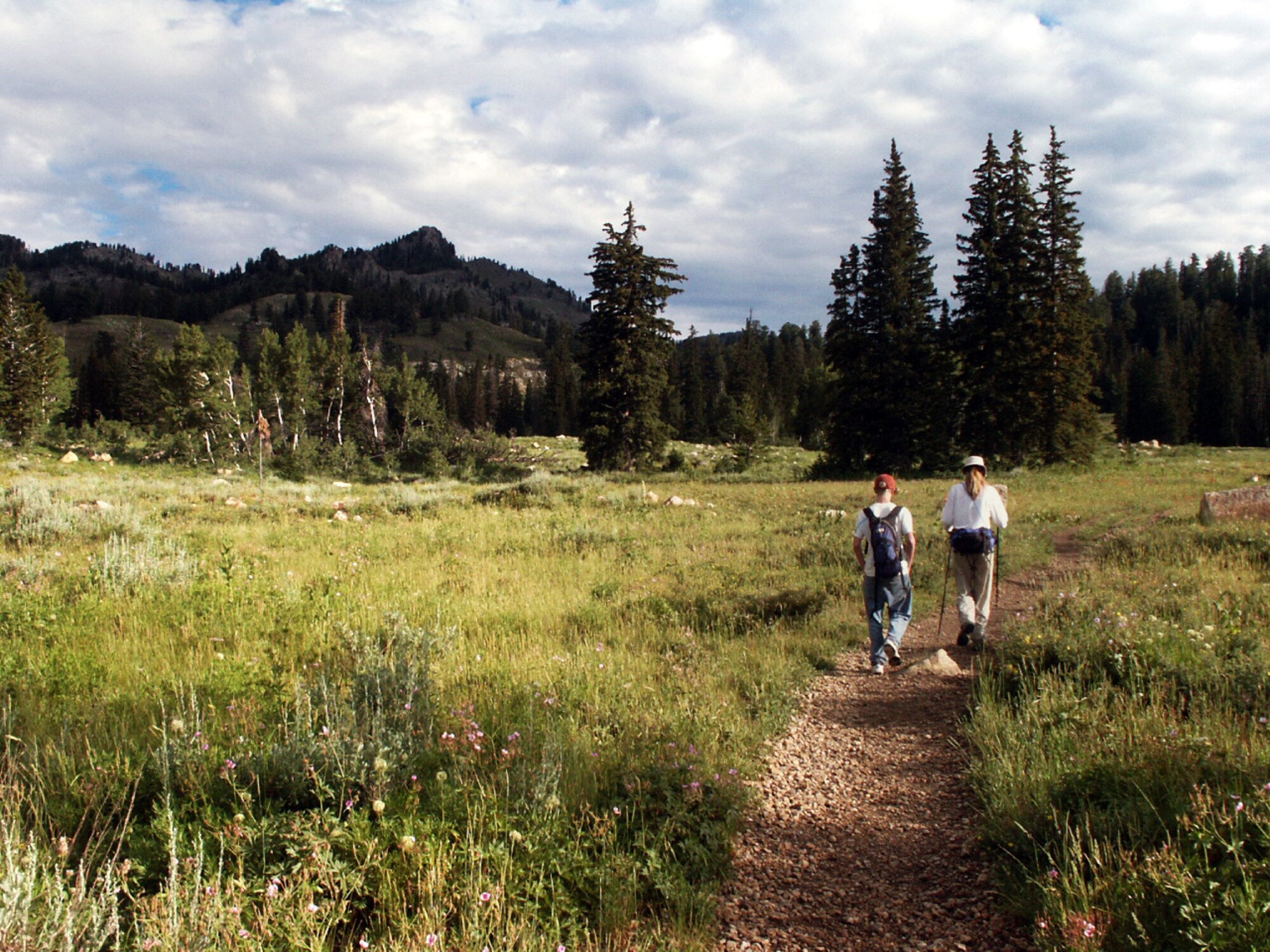 Cory Warburton and Jette Carr hike on a trail near Beaver Mountain Ski Resort, Utah, summer of 2003.  The hike was part of a trek spanning from the bottom to the top of Utah to each boarder – a journey that took 43 days and was nearly 700 miles long.  (Courtesy photo)
