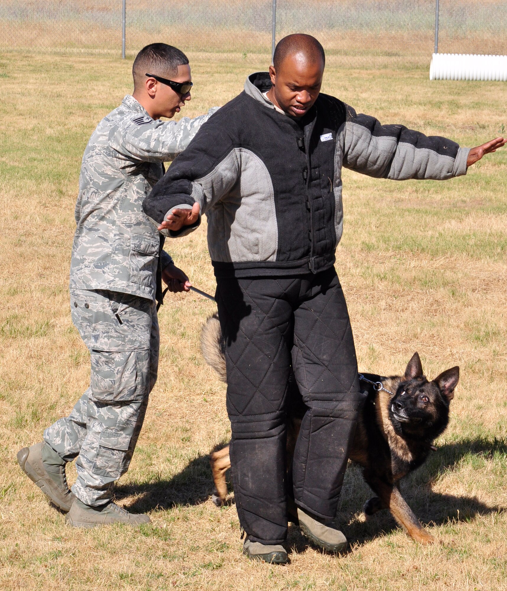 Staff Sgt. Christopher La Boy, 9th Security Forces military working dog trainer, escorts a suspect as Frigo, a MWD, provides overwatch during a training scenario at Beale Air Force Base, Calif., June 12, 2012. Handlers often play the role of suspect during this type of training. (Courtesy photo by Noelle Hoffman)