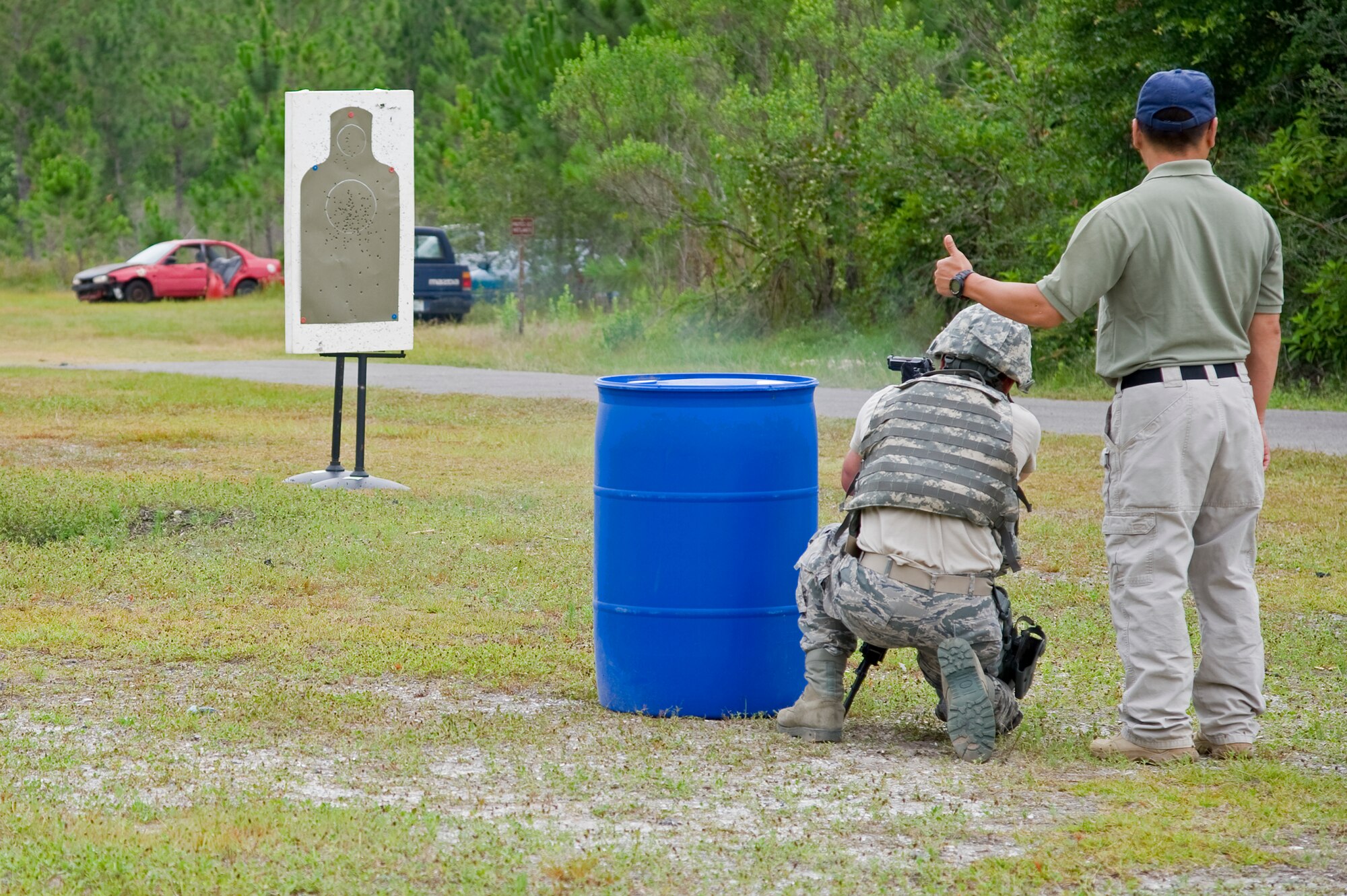 A Multi-Assault Counter-Terrorism Action Capabilities instructor gives Brent Tucker, a patrolman from the 1st Special Operations Security Forces Squadron, the thumbs-up for his performance during the live-fire portion of the MACTAC course at Hurlburt Field, Fla., June 8, 2012. The National Tactical Officers Association designed the course to train law enforcement professionals to stop an active shooter threat on base. (U.S. Air Force photo/Airman 1st Class Michelle Vickers)
