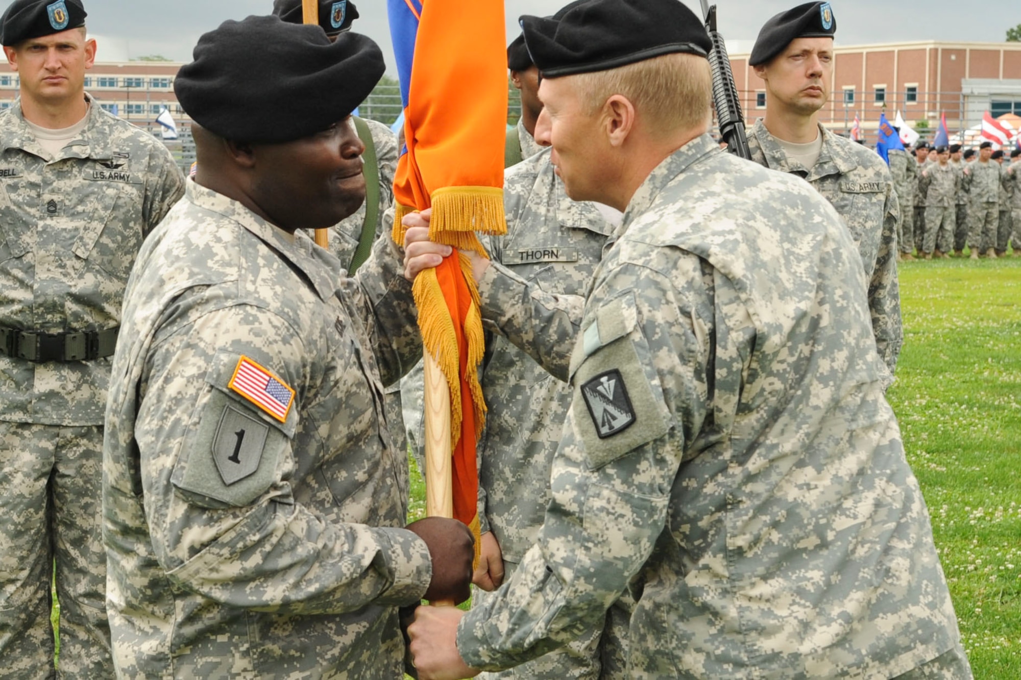 U.S. Army Col. Dean Heitkamp (right), 128th Aviation Brigade commander, passes the guideon to Command Sgt. Maj. John J. Moore, signifying the authority of his new role as brigade command sergeant major during a transfer of authority ceremony held at Murphy Field Sports Complex at Ft. Eustis, Va., June 12, 2012. Moore assumed responsibility of the brigade from Command Sgt. Maj. Lloyd G. Morant. (U.S. Air Force photo by Senior Airman Wesley Farnsworth/Released)