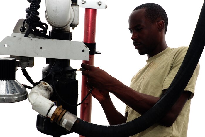 U.S. Air Force Senior Airman Anthony Burdett, 628th Logistics Readiness Squadron vehicle maintenance mechanic, checks a pump drain valve on a fire truck at Joint Base Charleston S.C., June 13, 2012. The 628th LRS vehicle maintenance shop consists of seven Airmen. (U.S. Air Force photo/ Airman 1st Class Chacarra Walker)