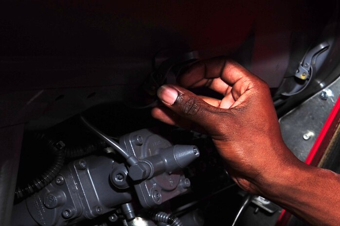 U.S. Air Force Senior Airman Anthony Burdett, 628th Logistics Readiness Squadron vehicle maintenance mechanic, checks roof turret electrical connections on a fire truck at Joint Base Charleston S.C., June 13, 2012. Technical school training for vehicle maintenance mechanics is 18-weeks long at Port Hueneme Naval Base, Calif. (U.S. Air Force photo/ Airman 1st Class Chacarra Walker)