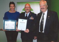 From left to right: Megan Eads, Tech. Sgt. Kevin Davis, and Bob Schure pose for a photo after Davis honors his employer with an ESGR award. Eads is Davis' supervisor at the Kerry Group and Schure is the ESGR awards coordinator for the state of Missouri. (USAF courtesy photo)
