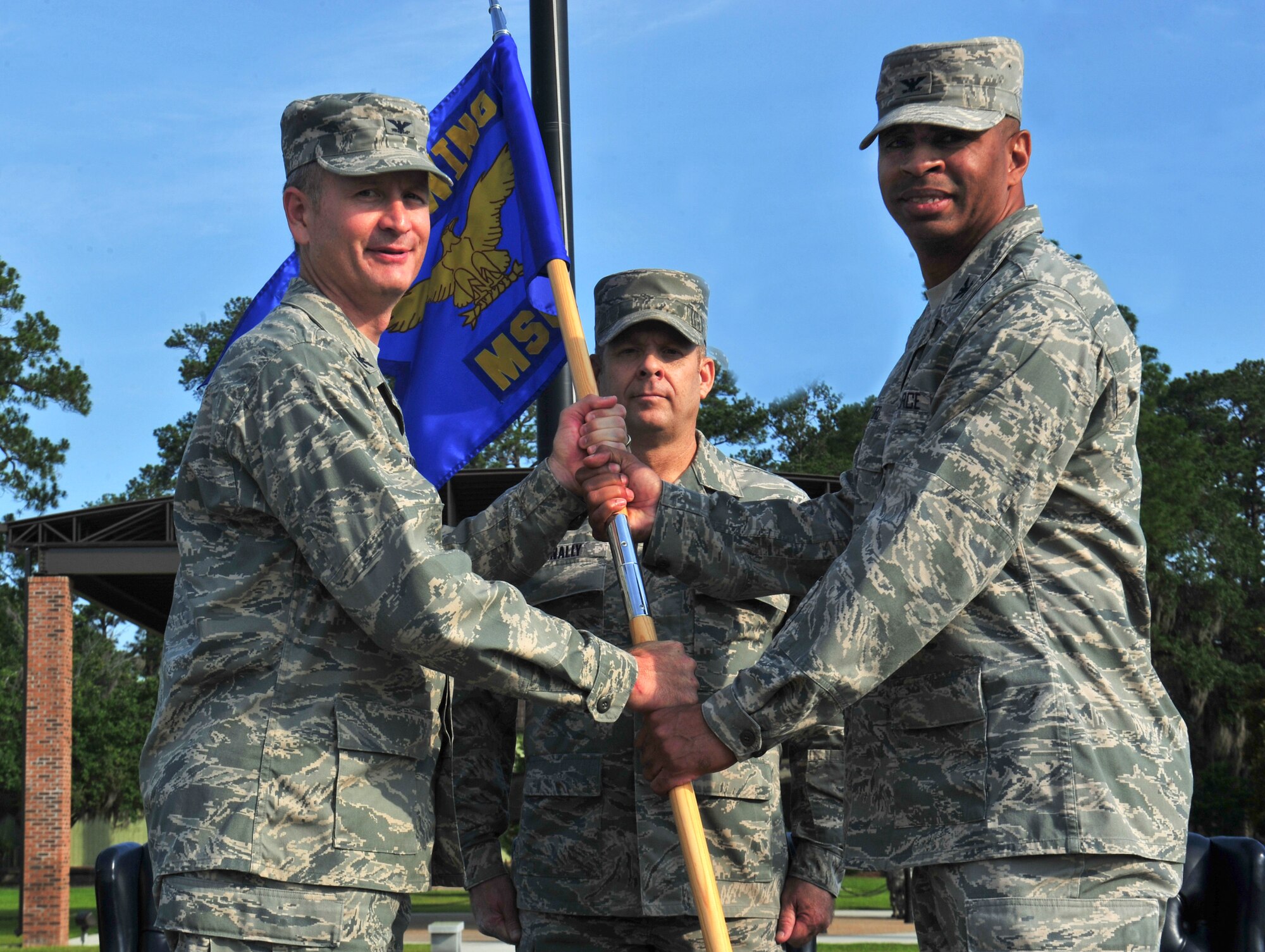 U.S. Air Force Col. Billy Thompson, 23d Wing commander, passes the guidon to Col. Edward Ford, incoming 23d Mission Support Group commander, during a change of command ceremony at Moody Air Force Base, Ga., June 15, 2012. Prior to assuming command of the group, Ford served as the director of manpower and personnel in the U.S. Cyber Command at Fort Meade, Md. (U.S. Air Force photo by Staff Sgt Stephanie Mancha/Released)
