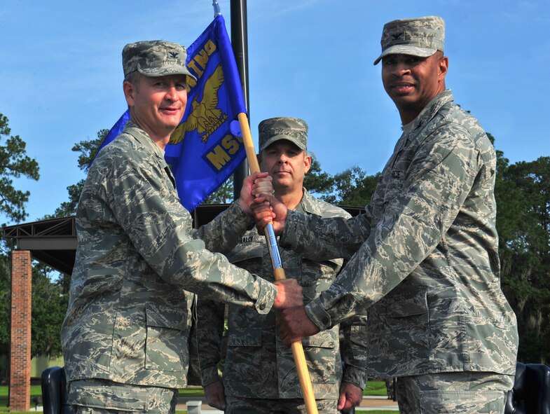U.S. Air Force Col. Billy Thompson, 23d Wing commander, passes the guidon to Col. Edward Ford, incoming 23d Mission Support Group commander, during a change of command ceremony at Moody Air Force Base, Ga., June 15, 2012. Prior to assuming command of the group, Ford served as the director of manpower and personnel in the U.S. Cyber Command at Fort Meade, Md. (U.S. Air Force photo by Staff Sgt Stephanie Mancha/Released)
