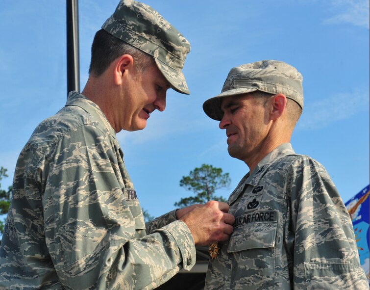 U.S. Air Force Col. Billy Thompson, 23d Wing commander, pins the Legion of Merit on Col. Mark Ruse, outgoing 23d Mission Support Group commander, at Moody Air Force Base, Ga., June 15, 2012. While in command of the 23d MSG, Ruse led and oversaw the completion of many projects that improved morale, welfare and quality of life on including a $10.2 million 93d Air Ground Operations Wing and MSG headquarters building. (U.S. Air Force photo by Staff Sgt. Stephanie Mancha/Released)