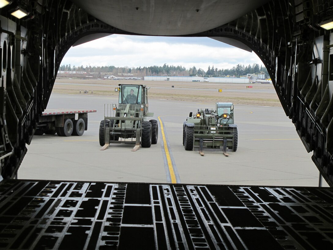 Reservists with the 86th Aerial Port Squadron, McChord Field, Wash., prepare to demonstrate loading equipment used with the C-17 during a joint training event here in March 2012. Experience like this is what Reserve aerial porters will take with them when they deploy to Southwest Asia later this summer.  (U.S. Air Force photo by Tech. Sgt. Michael Paredes)                                                         