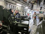 Tech. Sgt. Mark Smith, 86th Aerial Port Squadron, McChord Field, Wash., (right), supervises the upload of Navy equipment onto a C-17 during a joint training event here in March 2012. Experience like this is what Reserve aerial porters will take with them when they deploy to Southwest Asia later this summer. (U.S. Air Force photo by Tech. Sgt. Michael Paredes)             