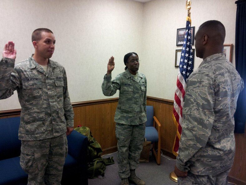 Staff Sgt. Jonathan Silvestri (left) and Staff Sgt.Lorenza Mitchell re-enlisted during the June unit training weekend. Both are reservists with the 916th Aircraft Maintenance Squadron. (USAF photo courtesy of 916AMXS)