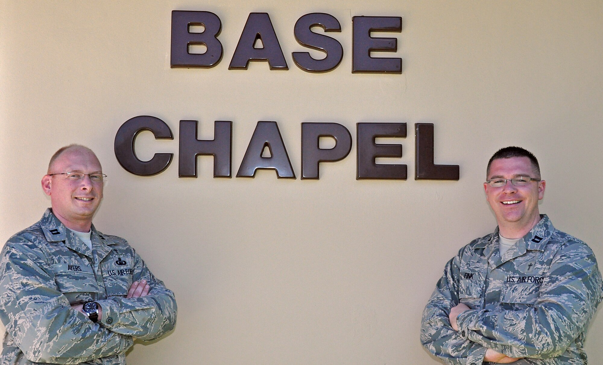 Chaplain Capt. Ryan Ayers (Left) and Chaplian Capt. Bradley Fink (Right) pose for a photo outside of the base chapel. Ayers and Fink are two of three chaplains that serve at the base chapel. (U.S. Air Force photo/Senior Airman Jacob Jimenez)