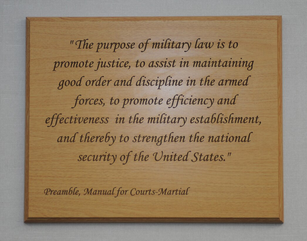 A plaque with an inscription from the preamble of the Manual for Courts-Martial adorns the wall of the Langley Air Force Base, Va. legal center. Judge Advocates who work at the center are constantly reminded by its words that their primary purpose is to promote justice. (U.S. Air Force photo by Senior Airman Jarad A. Denton/Released)