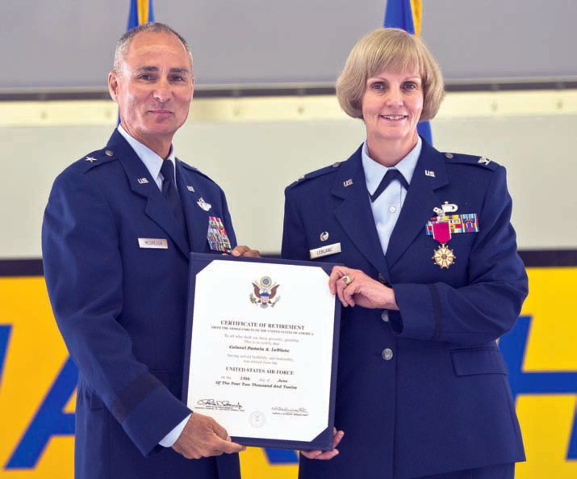 U.S. Air Force Brig. Gen. Karl McGregor, Commander of the 452d Air Mobility Wing, presents a retirement certificate to Col. Pamela A. LeBlanc, after she relinquished command of the 452d Mission Support Group, June 10. (U.S. Air Force photo by Tech. Sgt. Efren Lopez)