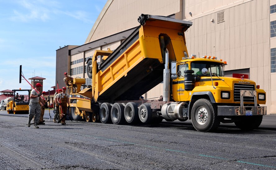 Airmen assigned to the 819th RED HORSE Squadron from Malmstrom Air Force Base, Mont., pave Pride Hangar parking lot at Ellsworth Air Force Base, S.D., June 12, 2012. RED HORSE units, constantly train constantly around the globe to prepare for missions anywhere in the world. (U.S. Air Force photo by Airman 1st Class Zachary Hada/Released)