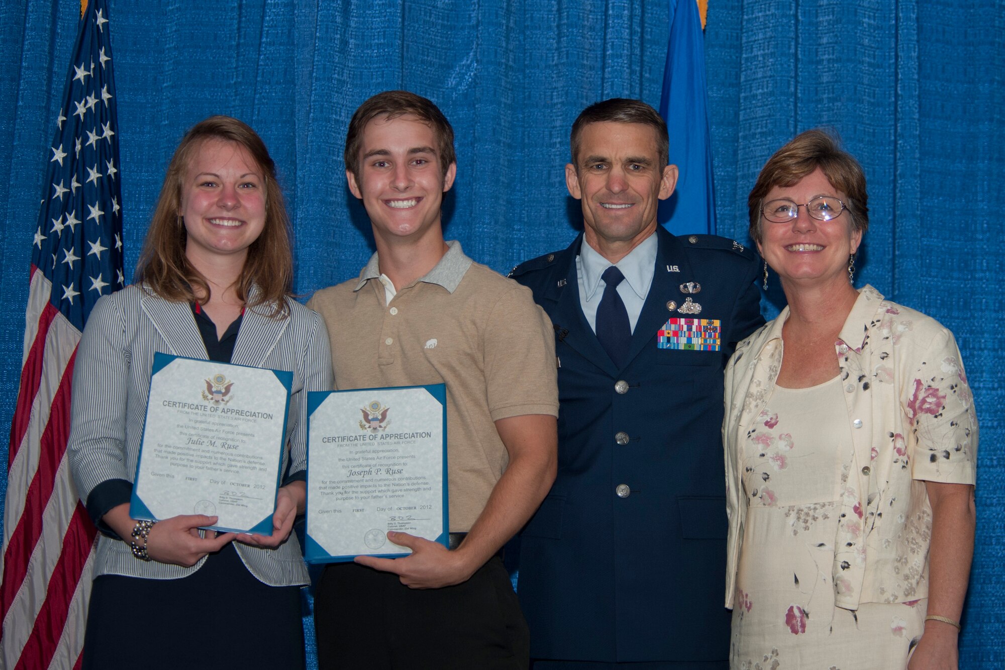 U.S. Air Force Col. Mark Ruse, former 23d Mission Support Group commander, poses for a photo with his children, Julie and Joey, and wife, Lisa, during a retirement ceremony June 15, 2012, at Moody Air Force Base, Ga. Ruse served more than 25 years in the Air Force. During the ceremony, his family was recognized for their commitment in supporting their father and husband. (U.S. Air Force photo by Staff Sgt. Jamal D. Sutter/Released)  