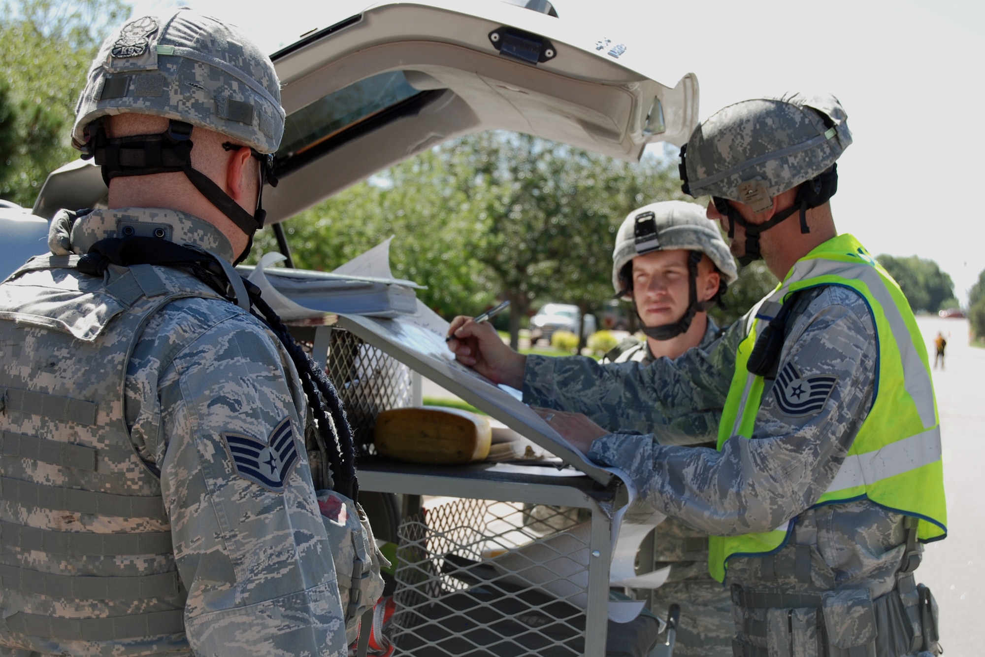 PETERSON AIR FORCE BASE, Colo. – 21st Security Forces Squadron members strategize during a bomb threat scenario in the Condor Crest exercise June 13, 2012. The purpose of the exercise is to ensure emergency preparedness in case of a real-world threat. (U.S. Air Force photo/Lea Johnson)