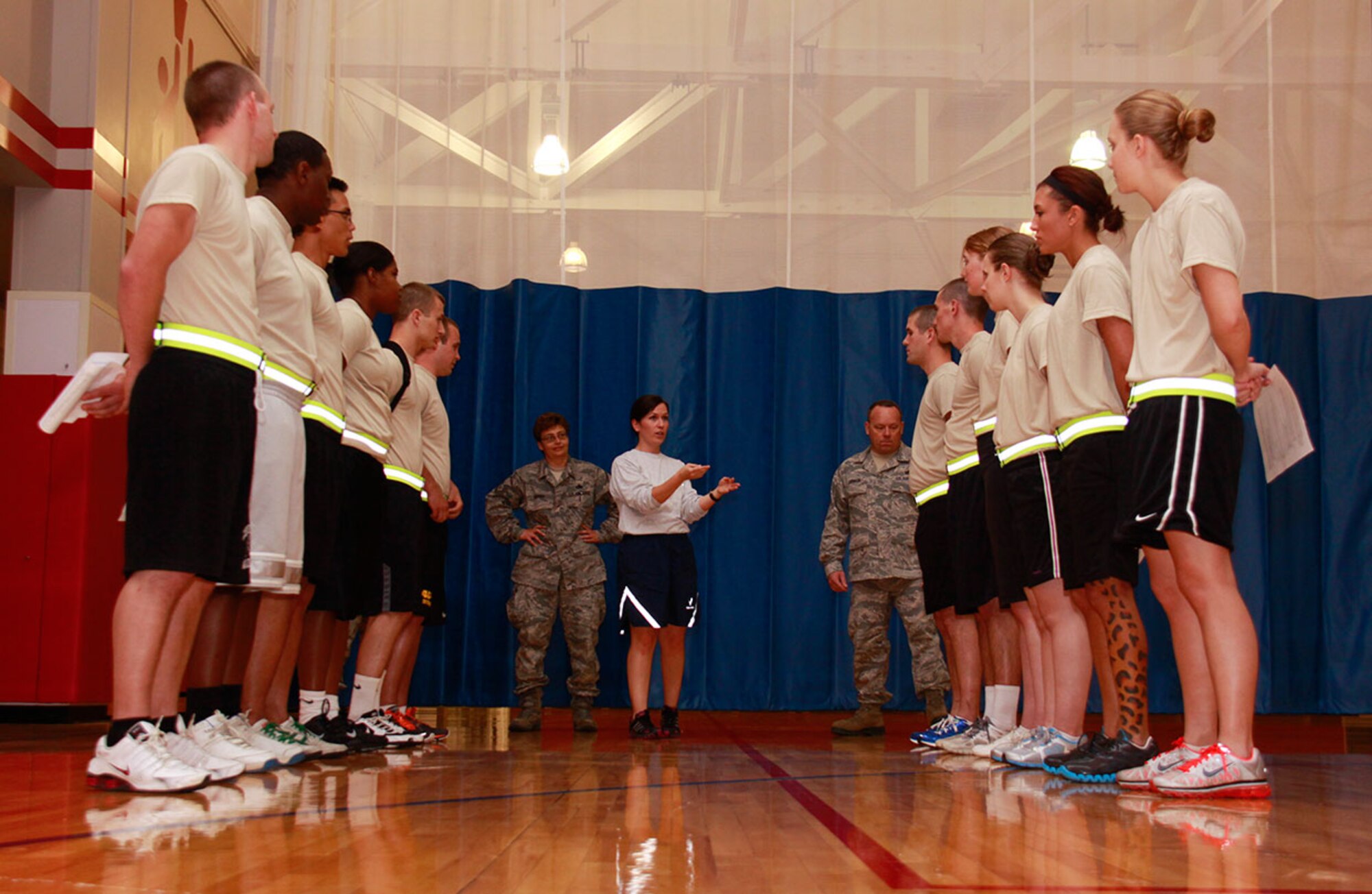 As a Fitness Program Manager, Staff Sgt. Jenna Black instructs the Development and Training Flight (DTF) on the time limit they have to complete their pushups during a Physical Training test in the Fitness Center of the 911th Airlift Wing, June 2, 2012. The DTF prepares for the physical regimen of basic training at the 911th during Unit Training Assemblies as well as performs drill and ceremony practice, reporting statements, and education on the Air Force customs and courtesies. (U.S. Air Force photo by Airman 1st Class Justyne Obeldobel/Released) 
