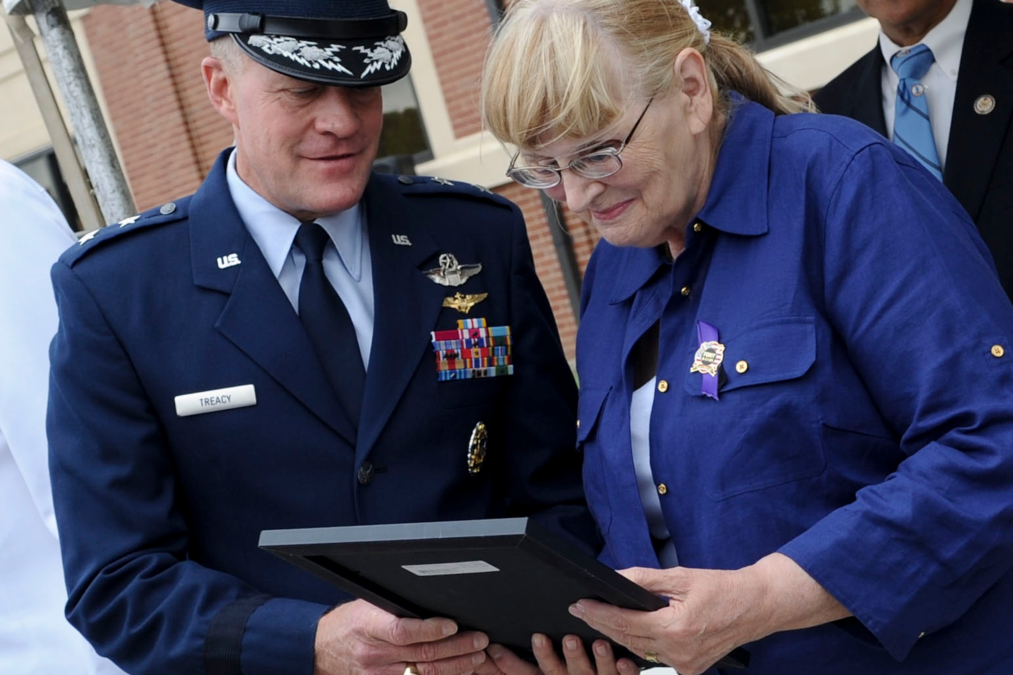 U.S. Air Force Maj. Gen. Jonathan T. Treacy, Joint Task Force-Civil Support commander, presents Theresa Mullan with the citation officially naming the JTF-CS headquarters building “Mullan Hall,” in honor of her late son, U.S. Army Capt. Michael D. Mullan, during the JTF-CS headquarters building dedication ceremony at Ft. Eustis, Va., June 14, 2012. Mullan, a reservist, emergency room nurse and decorated New York City firefighter, died while attempting to rescue fellow firefighters from the Marriott Hotel adjacent to the World Trade Center towers during the terrorist attacks of Sept. 11, 2001. (U.S. Air Force photo by Senior Airman Wesley Farnsworth/Released)