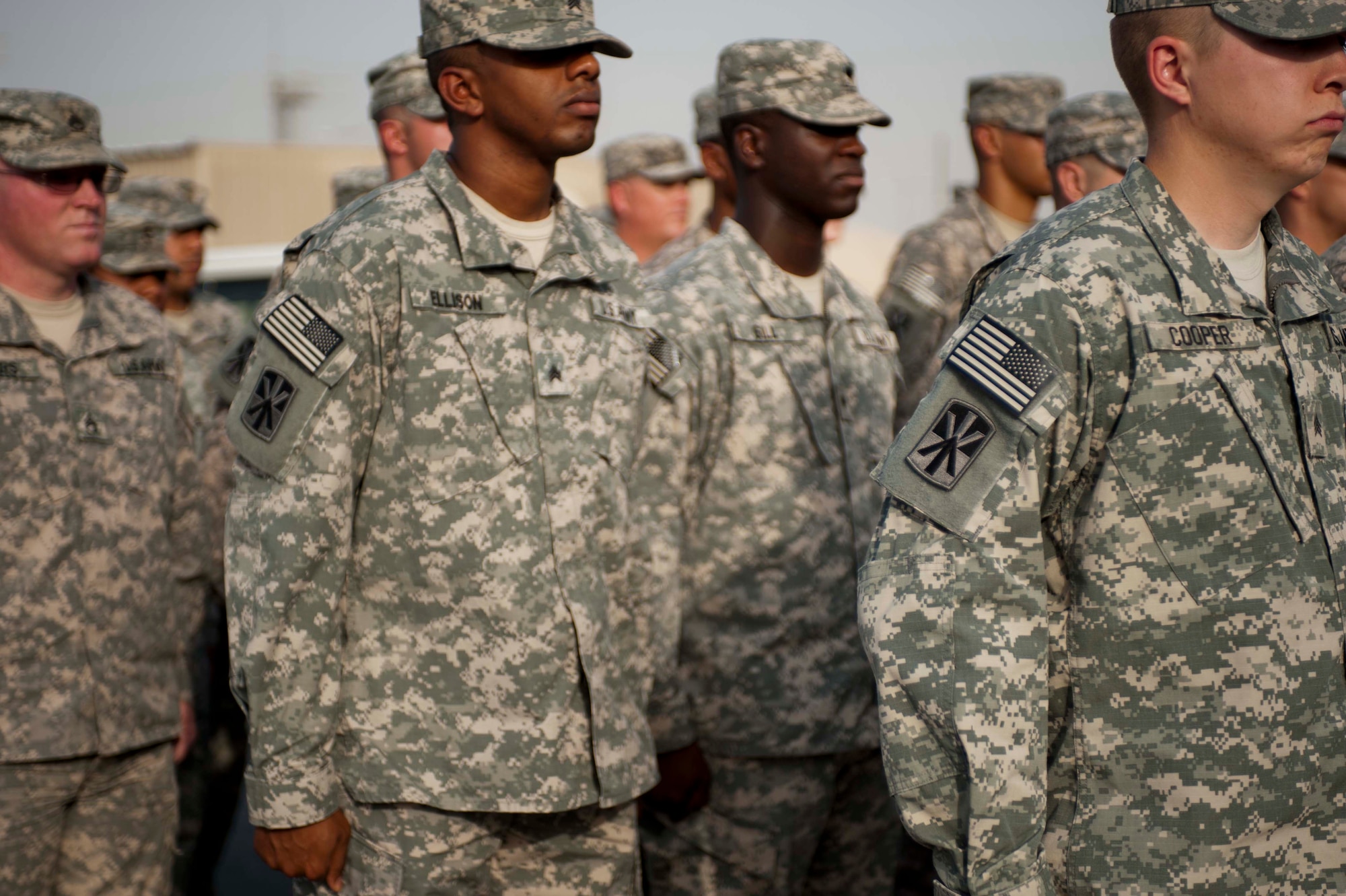Soldiers from the 11th Air Defense Artillery "Imperial" Brigade are awarded the brigade patch on their right shoulder by Col. Reginald Davis the 11th ADA brigade commander at a ceremony at the forward deployed brigade area on June 14. The patch, when worn on the right shoulder, signifies it as a "combat patch" and was awarded for their service in supporting Operation ENDURING FREEDOM while assigned to the 11th Brigade while deployed. (U.S. Air Force photo/Staff Sgt. Sheila deVera)