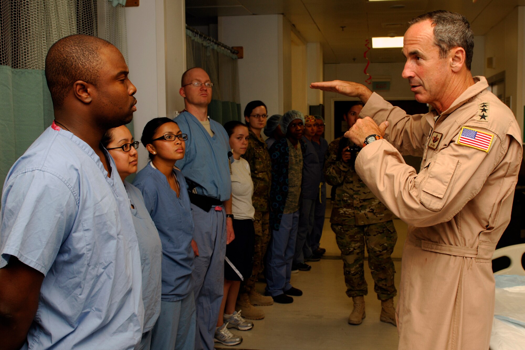 Members of the Craig Joint Theater Hospital listen while Gen. Raymond Johns, Jr., Air Mobility Command commander, discusses the importance of their mission at Bagram Airfield, Afghanistan, June 16, 2012. Johns expressed his appreciation to the members of CJTH for their hard work and dedication to saving the lives of injured military service members and local civilians. (U.S. Air Force photo/Staff Sgt. Jeff Nevison) 