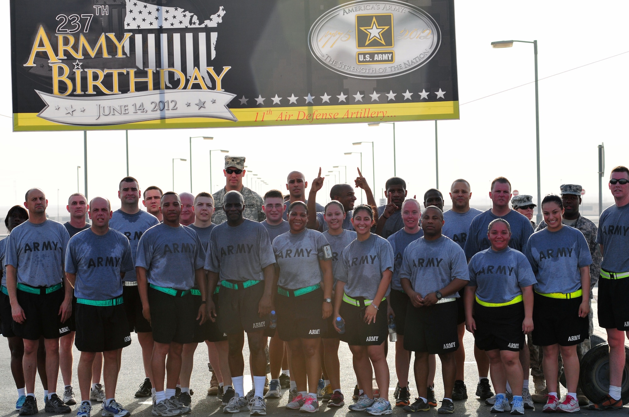 Soldiers from the 11th Air Defense Artillery pose for a photograph under the 237th Army Birthday banner shortly after running 5k supporting the Army birthday on June 14 near the base gym in Southwest Asia. (U.S. Army photo/Sgt. Todd Robinson)