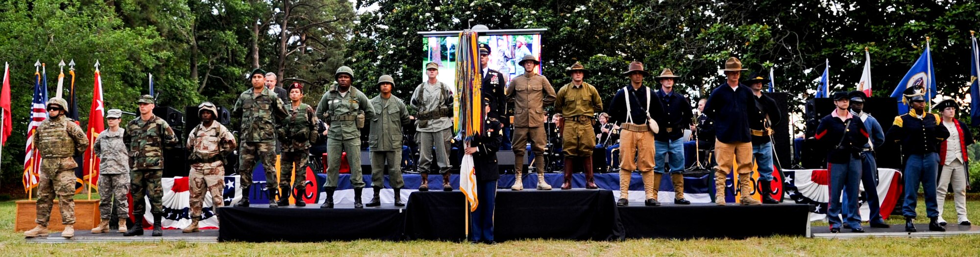 Soldiers adorned in various historic U.S. Army uniforms stand in formation during the “Music Under the Stars” performance at Ft. Eustis' Magnolia Park as part of the 237th Army Birthday celebration, June 14, 2012. The Soldiers wore the uniforms as part of a special streamer ceremony, honoring the history of the U.S. Army. The Army is the largest and oldest branch of the U.S. Armed Forces. (U.S. Air Force photo by Senior Airman Wesley Farnsworth/Released)