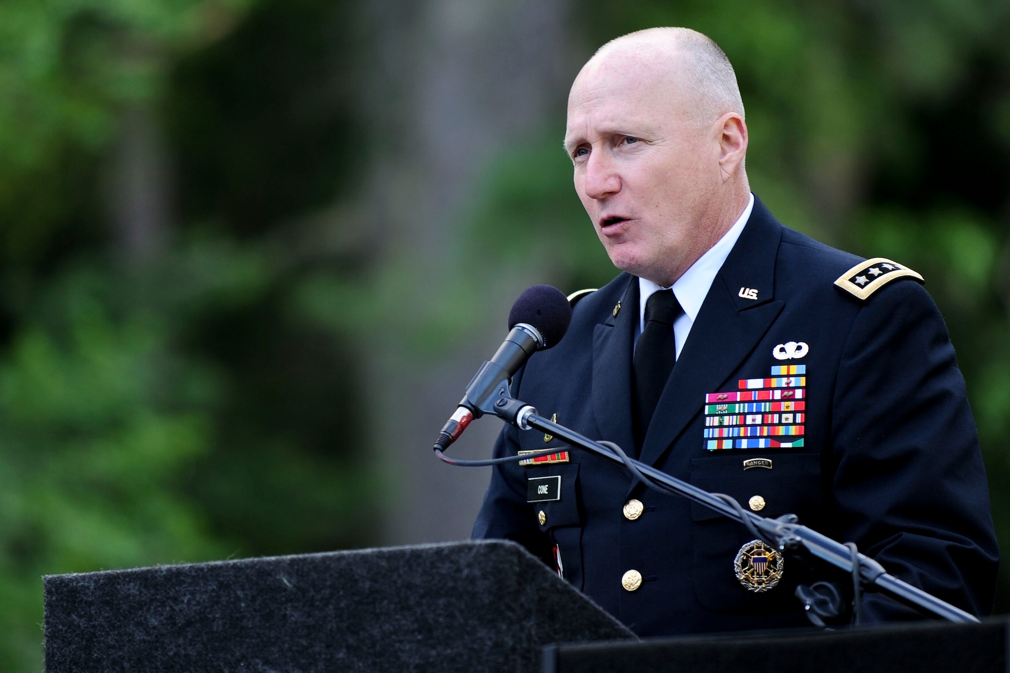 U.S. Army Gen. Robert Cone, commanding general of U.S. Army Training and Doctrine Command, addresses the crowd during the “Music Under the Stars” performance at Ft. Eustis' Magnolia Park as part of the 237th Army Birthday celebration, June 14, 2012. The celebration included a cake cutting, streamer ceremony and patriotic performance by the TRADOC Band. (U.S. Air Force photo by Senior Airman Wesley Farnsworth/Released)