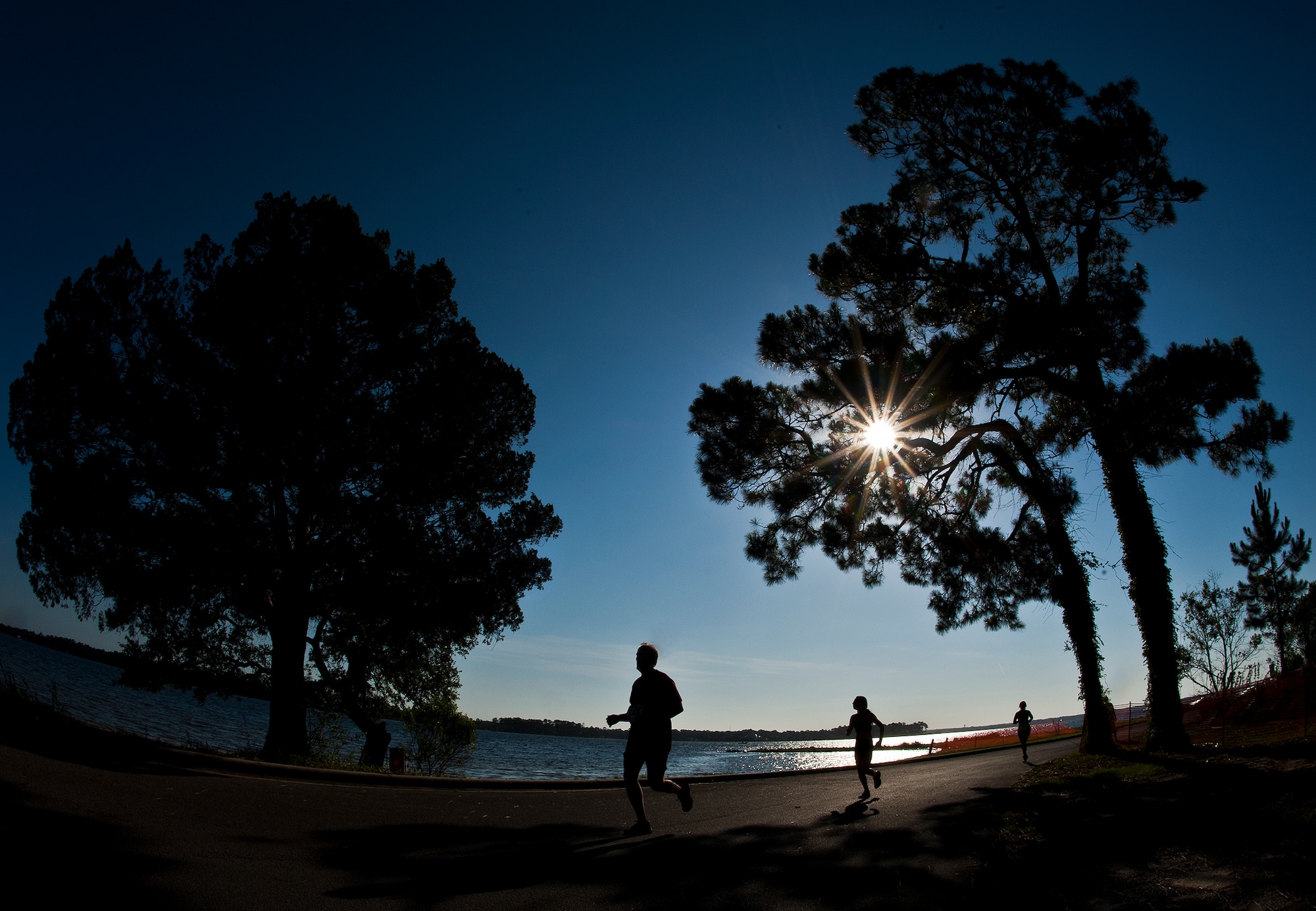 Runners stride to the finish of the two and a half-mile run of the My-First-Tri competition June 16 at Eglin Air Force Base, Fla.  More than 140 people competed in the 13th annual base triathlon.  (U.S. Air Force photo/Samuel King Jr.)