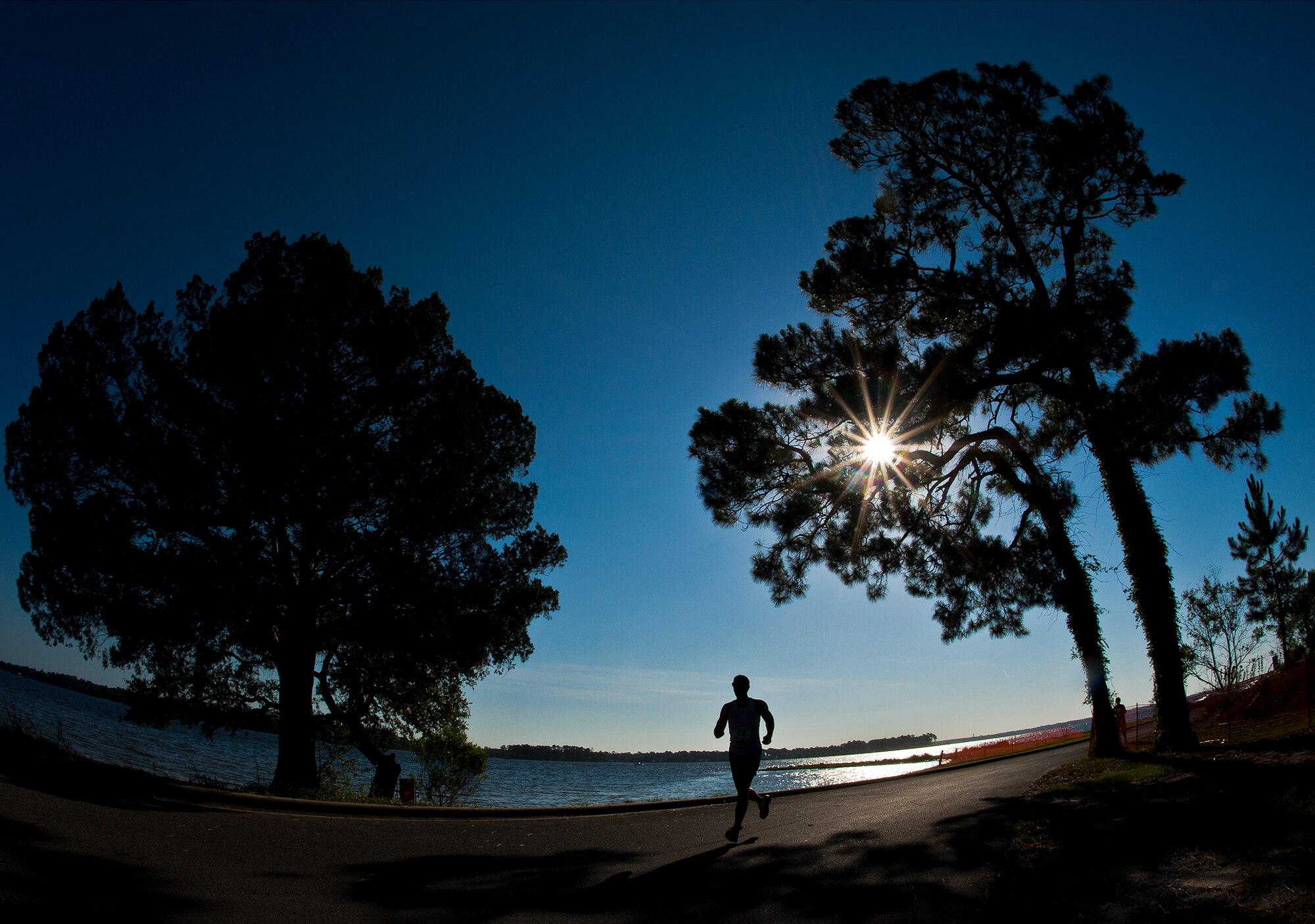 Runners stride to the finish of the two and a half-mile run of the My-First-Tri competition June 16 at Eglin Air Force Base, Fla.  More than 140 people competed in the 13th annual base triathlon.  (U.S. Air Force photo/Samuel King Jr.)