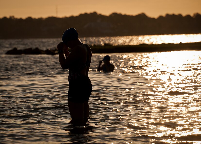 A female participant prepares her swim cap for the first leg of the My-First-Tri competition June 16 at Eglin Air Force Base, Fla.  More than 140 people competed in the 13th annual base triathlon.  (U.S. Air Force photo/Samuel King Jr.)