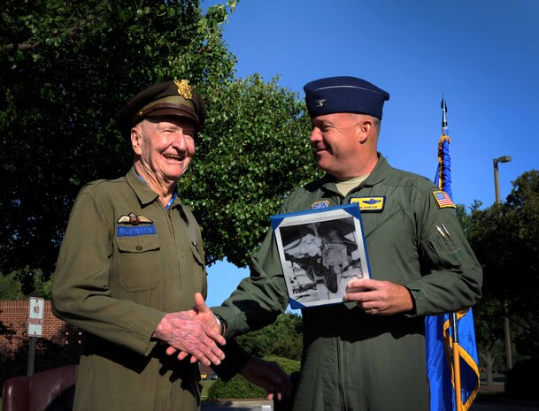 Retired Col. Gail Halvorsen, the famed "Candy Bomber", is handed a certificate by Col. Erik Hansen, 437th Airlift Wing commander, moments after the C-17 Aircrew Training Center was dedicated in honor of him, as one of the finest mobility legends. Halvorsen was a command pilot in the United
States Air Force. He is best known for piloting C-47s and C-54s during the Berlin Airlift from 1948-1949. Halvorsen dropped candy attached to parachutes to children below. His main goal was to raise the morale of the children during the time of uncertainty. (U.S. Air Force photo/Airman 1st
Class Ashlee Galloway)



