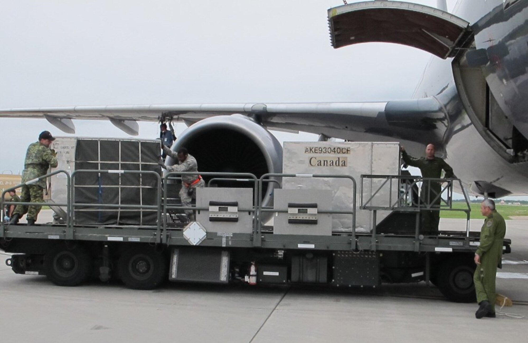 Senior Airman Edward Johnson, 46th Aerial Port Squadron, Dover Air Force Base, Del., helps Royal Canadian Air Force members load an aircraft June 1, 2012, during the Maple Flag international air combat exercise in Cold Lake, Alberta, Canada. (Courtesy photo)
