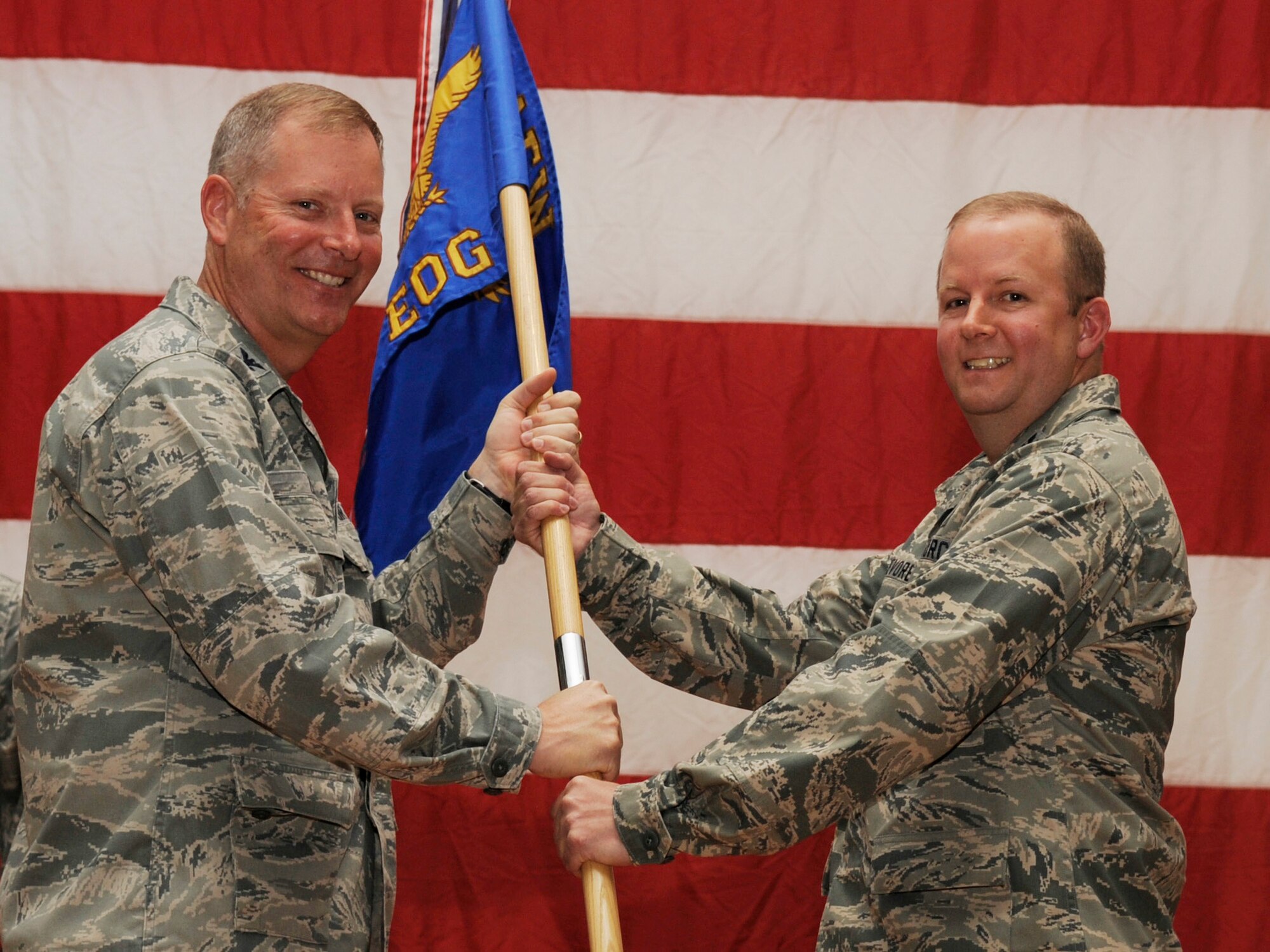 SOUTHWEST ASIA - Col. Michael Zick, 386th Air Expeditionary Wing commander, gives the 386th Expeditionary Operations Group guideon to Col. Jeffrey Devore, during the change of command ceremony here June 18, 2012. (U.S. Air Force photo/Staff Sgt. Alexandra M. Boutte)