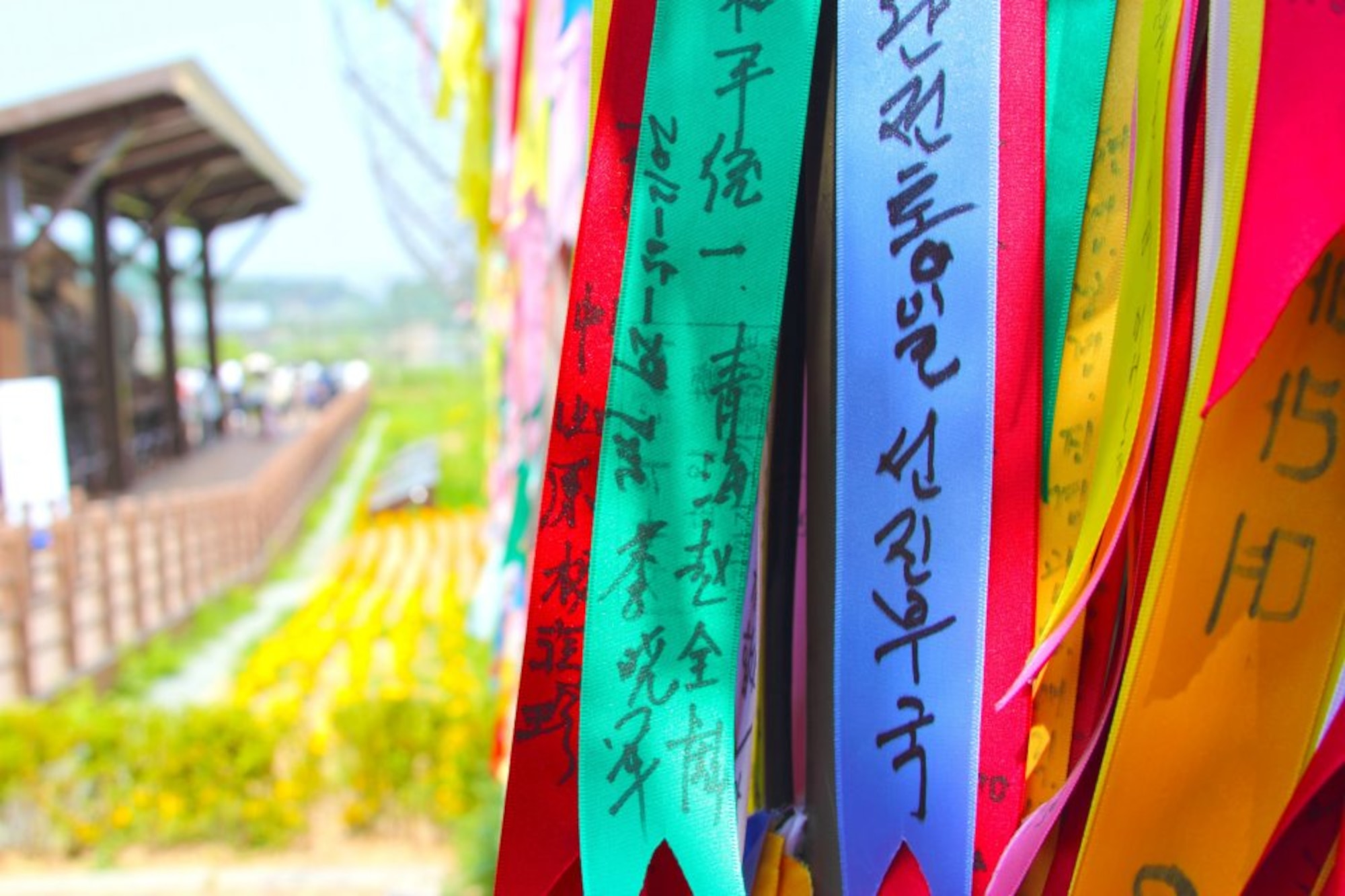 Ribbons hang from a secured fence at Imjingak, South Korea, near the Demilitarized Zone. Family members write messages on ribbons and tie them to the fence to send prayers to loved ones in North Korea who were displaced as part of the Korean War. (U.S. Air Force photo/Staff Sgt. Brice Gaston)