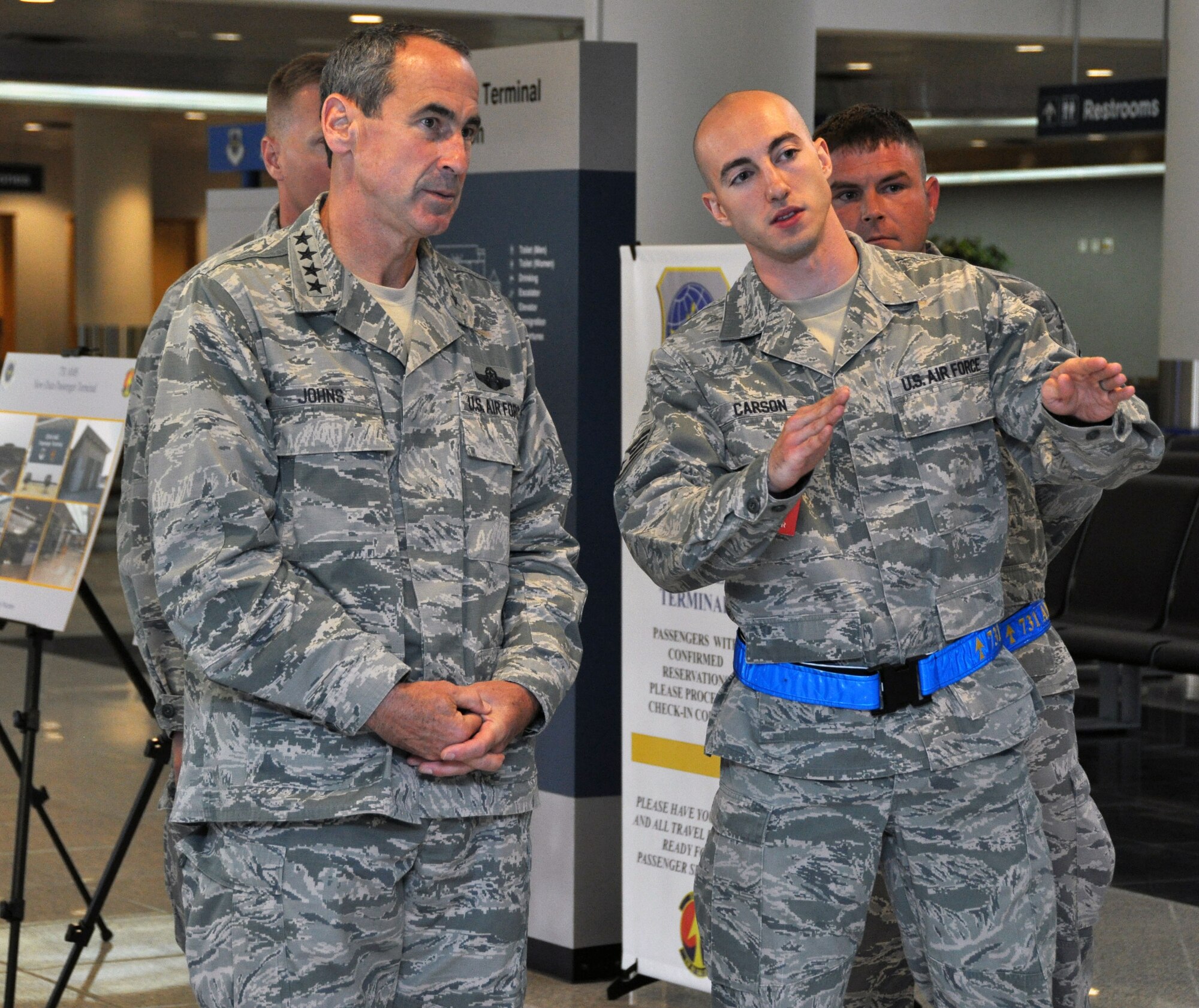Staff Sgt. Charles Carson briefs Gen. Raymond Johns Jr., Air Mobility Command commander, on the capabilities and processes of the Osan Air Base, Republic of Korea passenger terminal, June 13, 2012. Carson is a passenger service supervisor with the 731st Air Mobility Squadron. (U.S. Air Force photo/Senior Airman Michael Battles)