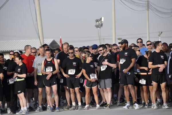 KANDAHAR AIRFIELD, Afghanistan — Runners from all over Kandahar Airfield await the start of the Engineer Day 5-kilometer run, June 16, 2012. Runner number 376, Royal Air Force Sgt. Paul Vernon (left front), was the first place finisher. The first place female runner was a U.S. Army runner 2nd Lt. Jennifer Han who works at the KAF medical center.