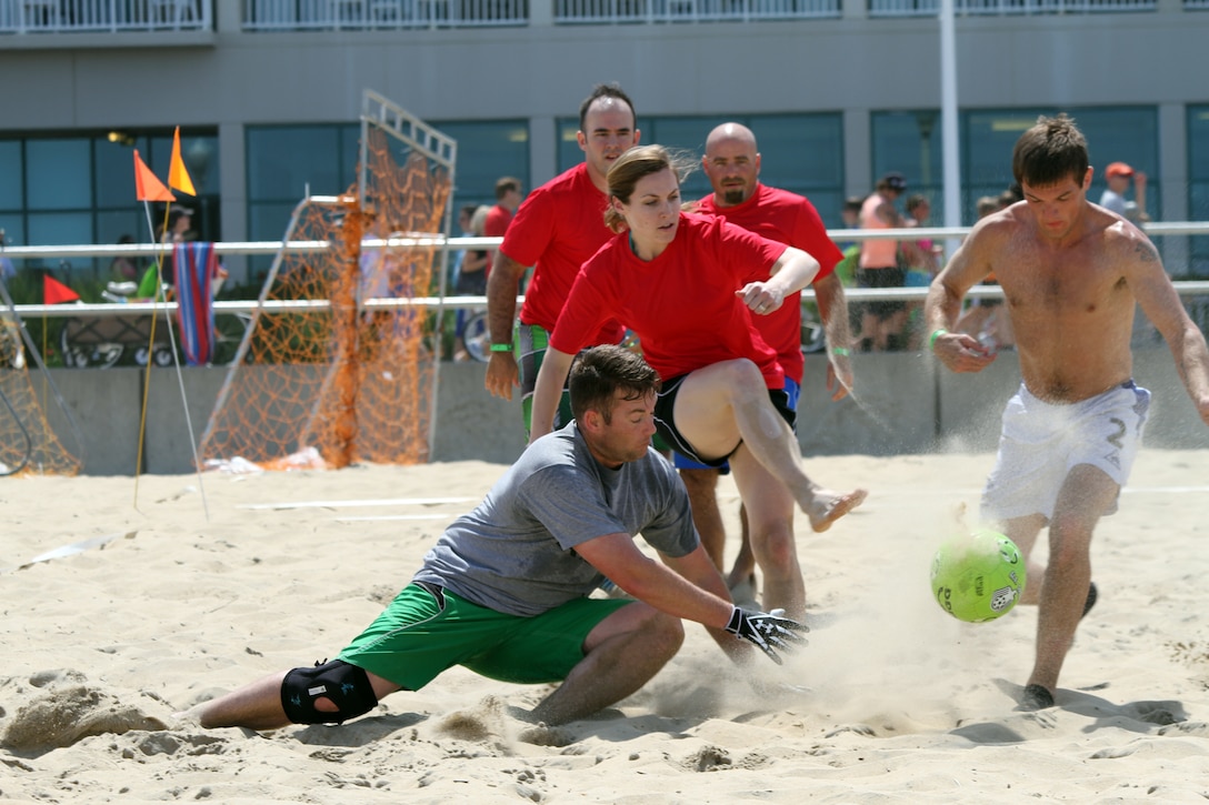 VIRGINIA BEACH, Va. -- Go Army, Beat Royal navy...and they did! Corps goalie Tom Booth blocks a goal while teammates Tony Pazos, Michelle Booth and Christian Brumm back him up. The Corps Kickers were victorious in their game against the Royal navy June 9 with a 6-4 win. The game was the first of three in the International Military Division for OpSail2012's sand soccer tournament in Virginia Beach. (U.S. Army photo/Pamela K. Spaugy)