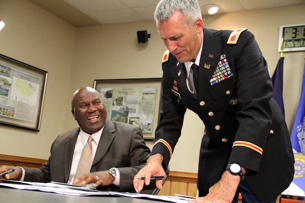 Jerry Bridges, Port of Virginia's executive director, and Col. Paul Olsen, Norfolk District commander, sign a Project Partnership Agreement this afternoon for the Craney Island Eastward Expansion project. This Corps-VPA partnership will have significant impacts on the local, regional, and national economy, doubling the capacity of the Port and generating more than 56,000 jobs over time.