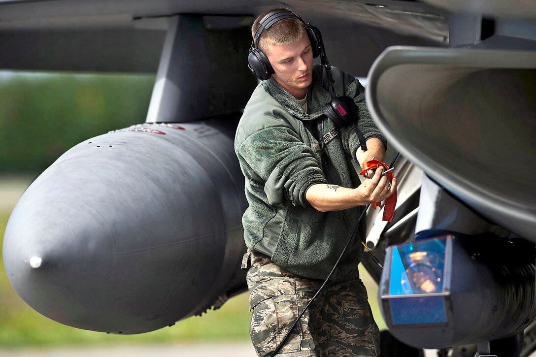U.S. Air Force Staff Sgt. John Minnich inserts a pin not used during flight back into an F-16 Fighting Falcon as it returns from combat training during Red Flag-Alaska 12-2 on Eielson Air Force Base, Alaska, June 14, 2012. Minnich, a crew chief, is assigned to the 20th Aircraft Maintenance Squadron, Shaw Air Force Base, S.C.