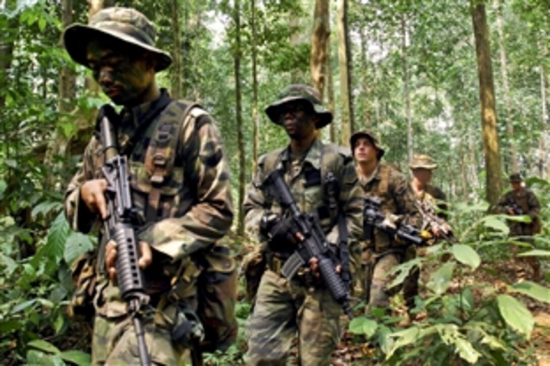 U.S. Marines and Malaysian soldiers conduct an ambush exercise during Cooperation Afloat Readiness and Training Malaysia 2012 in Beraus, Malaysia, June 17, 2012. The bilateral military exercises occur between the U.S. Navy and the armed forces of Bangladesh, Brunei, Cambodia, Indonesia, Malaysia, the Philippines, Singapore, and Thailand. Timor Leste joined the exercise for the first time this year.