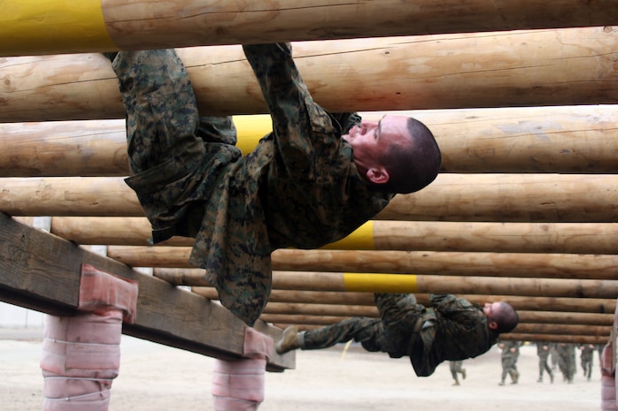 Recruits of Company F, 2nd Recruit Training Battalion, challenge the Weaver, an obstacle on Confidence Course June 4 aboard Marine Corps Recruit Depot San Diego. The Confidence Course is an event that requires recruits to push physically and mentally through any fear of a difficult obstacle.