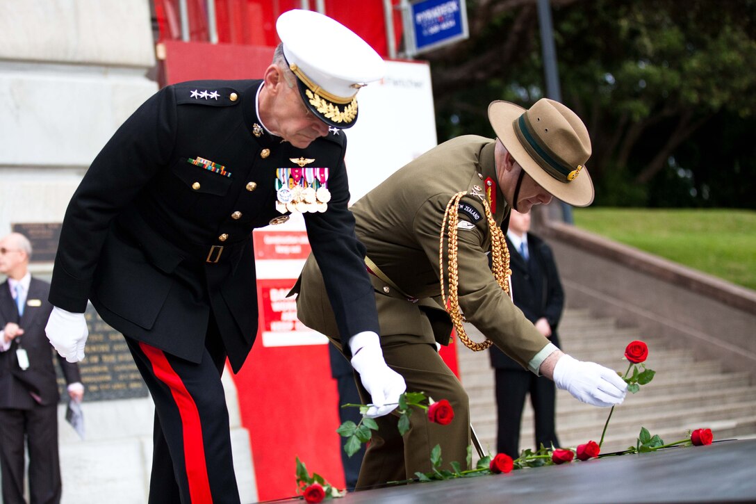 WELLINGTON, New Zealand - Lt. Gen. Duane D. Theissen (left), commander of U.S. Marine Corps Forces, Pacific, and Lt. Gen. Rhys Jones, New Zealand chief of defense force, place roses on the tomb of the unknown warrior at the National War Memorial here June 14. Theissen, along with Maj. Gen. Ronald Bailey, commander of 1st Marine Division, were present at the wreath-laying ceremony to commemorate the 70th anniversary of U.S. Marines landing in Wellington during World War II. (U.S. Marine Corps photo by: Cpl. Isis Ramirez/released)