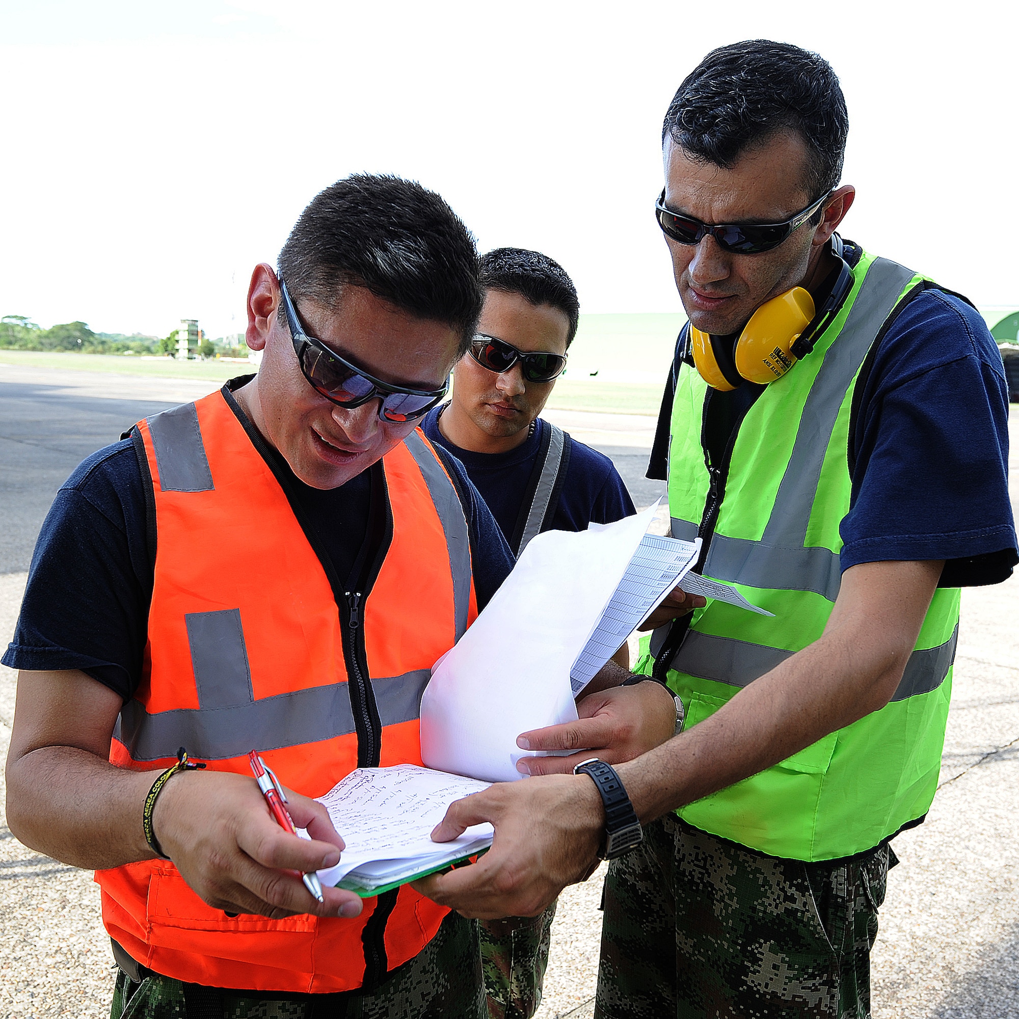 The production superintendent goes over each aircrafts status with the crew chiefs prior to the evening's flights June 15, at Comando Aéreo de Combate No. 1 base, Palanquero, Colombia, as part of a month-long Air Mobility Command Building Partner Capacity mission. (U.S. Air Force photo by Tech. Sgt. Lesley Waters)