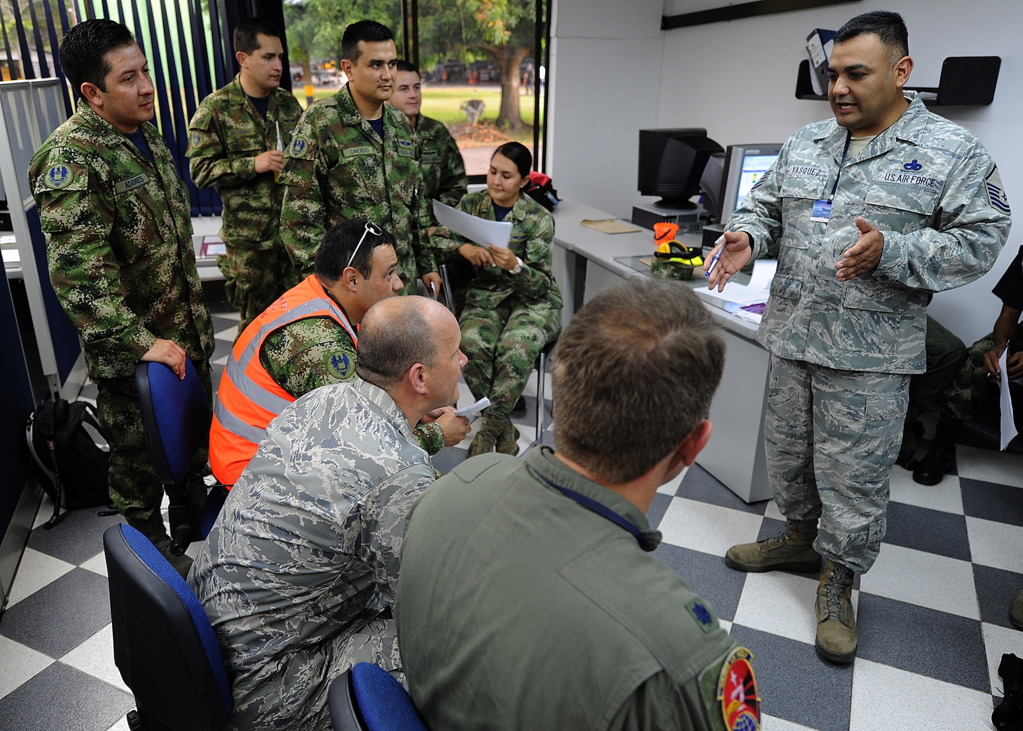 Master Sgt. Roberto Vasquez, 12th AF (AFSOUTH) heavy aircraft manager, shows the Colombian air force the proper way of providing a maintenance operations center briefing to senior leadership June 14, at Comando Aéreo de Combate No. 1 base, Palanquero, Colombia, as part of a month-long Air Mobility Command Building Partner Capacity mission. (U.S. Air Force photo by Tech. Sgt. Lesley Waters)