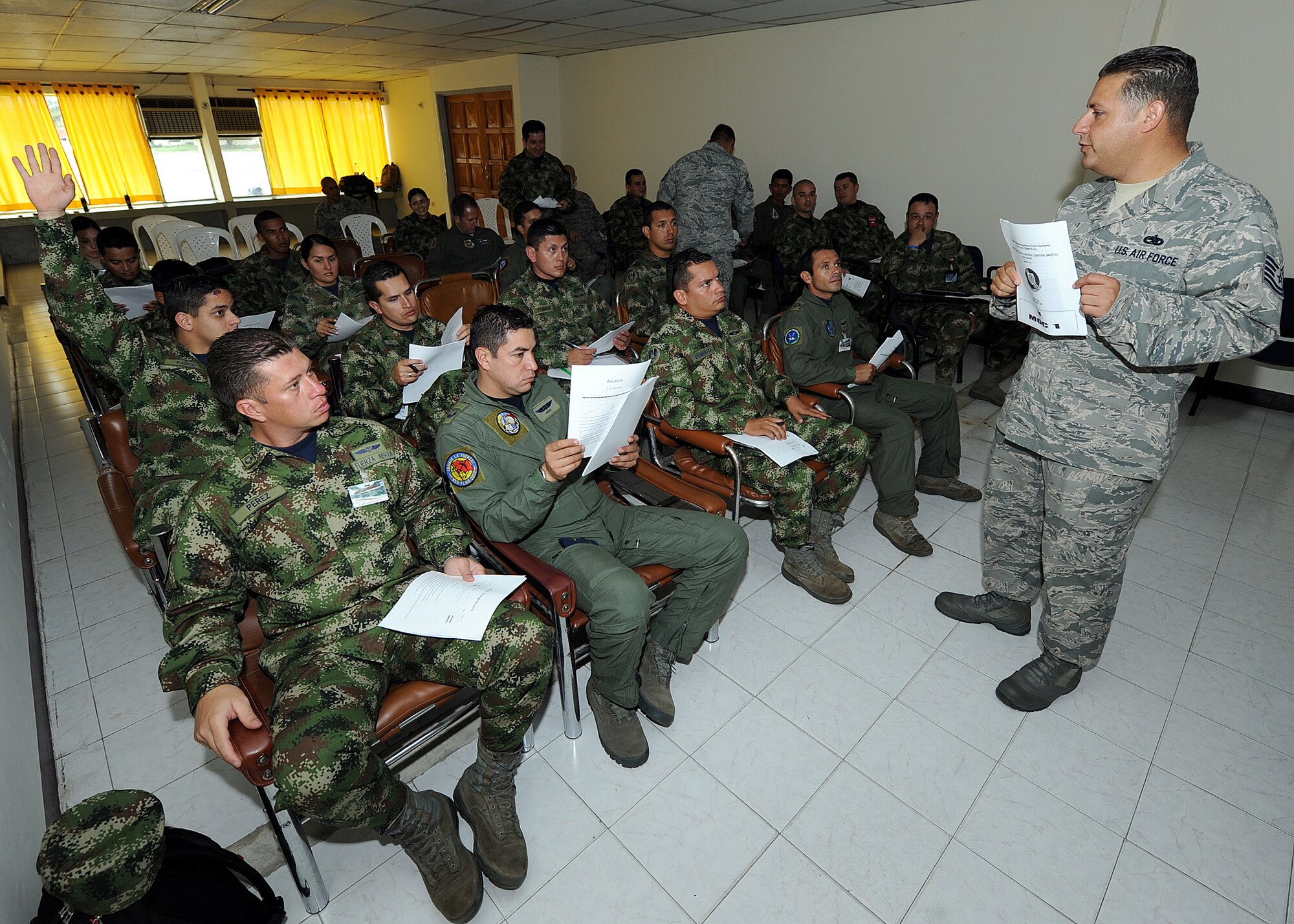 Technical Sgt. Melvin Rosario, Inter-American Air Forces Academy instructor, goes over the maintenance operations center hand out during the first day of MOC seminars June 12, at Comando Aéreo de Combate No. 1 base, Palanquero, Colombia, as part of a month-long Air Mobility Command Building Partner Capacity mission. (U.S. Air Force photo by Tech. Sgt. Lesley Waters)
