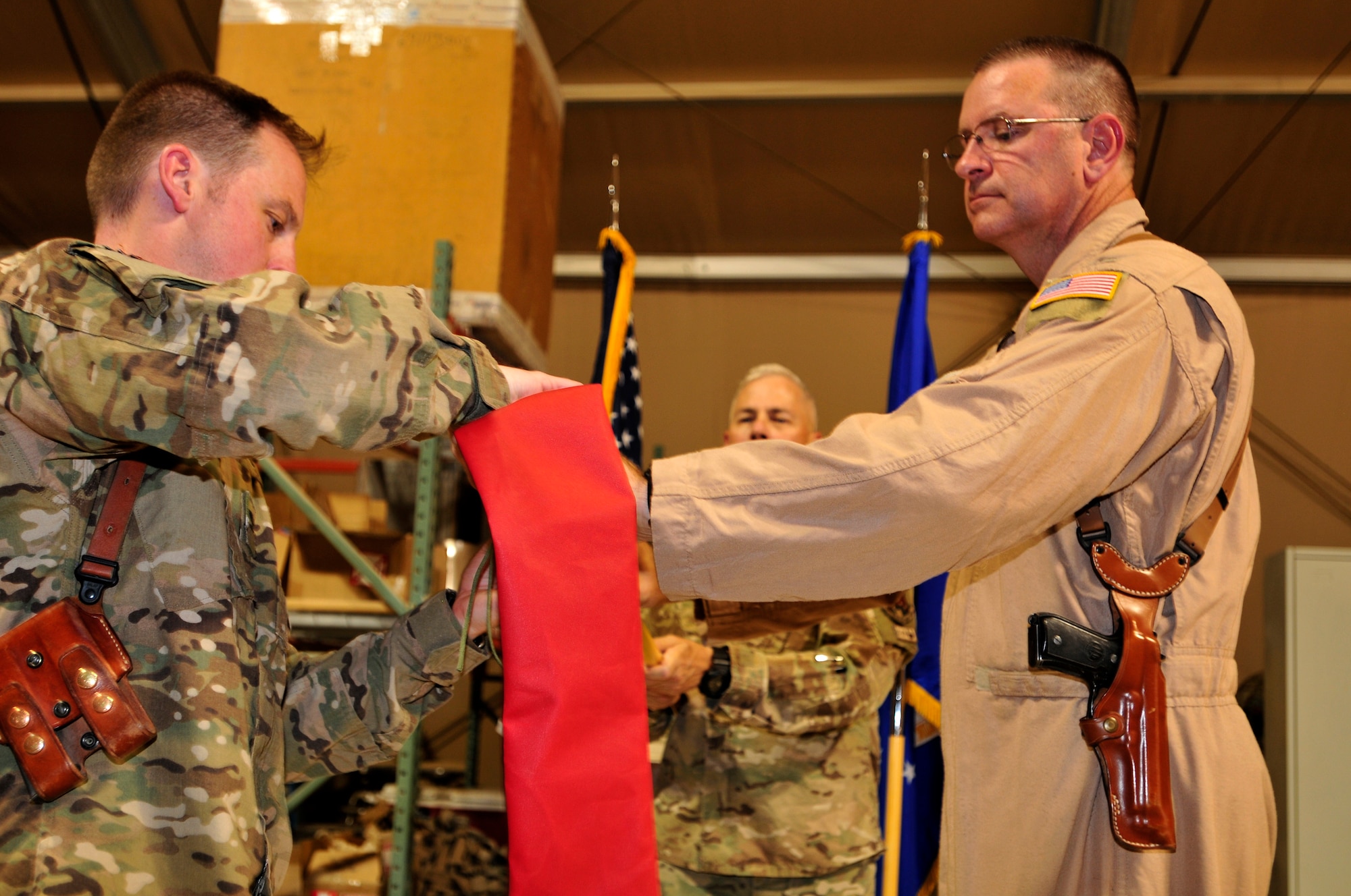 Col. Robert Kiebler, commander, 451st Expeditionary Operations Group and Lt. Col. Mike Lunt, commander, 702nd Expeditionary Airlift Squadron case the squadron colors at a deactivation ceremony at Kandahar Airfield.  Casing the colors signifies the full deactivation of the squadron. The squadron was established in July 2011 and was deactivated on Monday.  The squadron supported tactical airlift requirements in support of operations in Afghanistan (U.S. Army Photo - Sgt. Daniel J. Schroeder)
