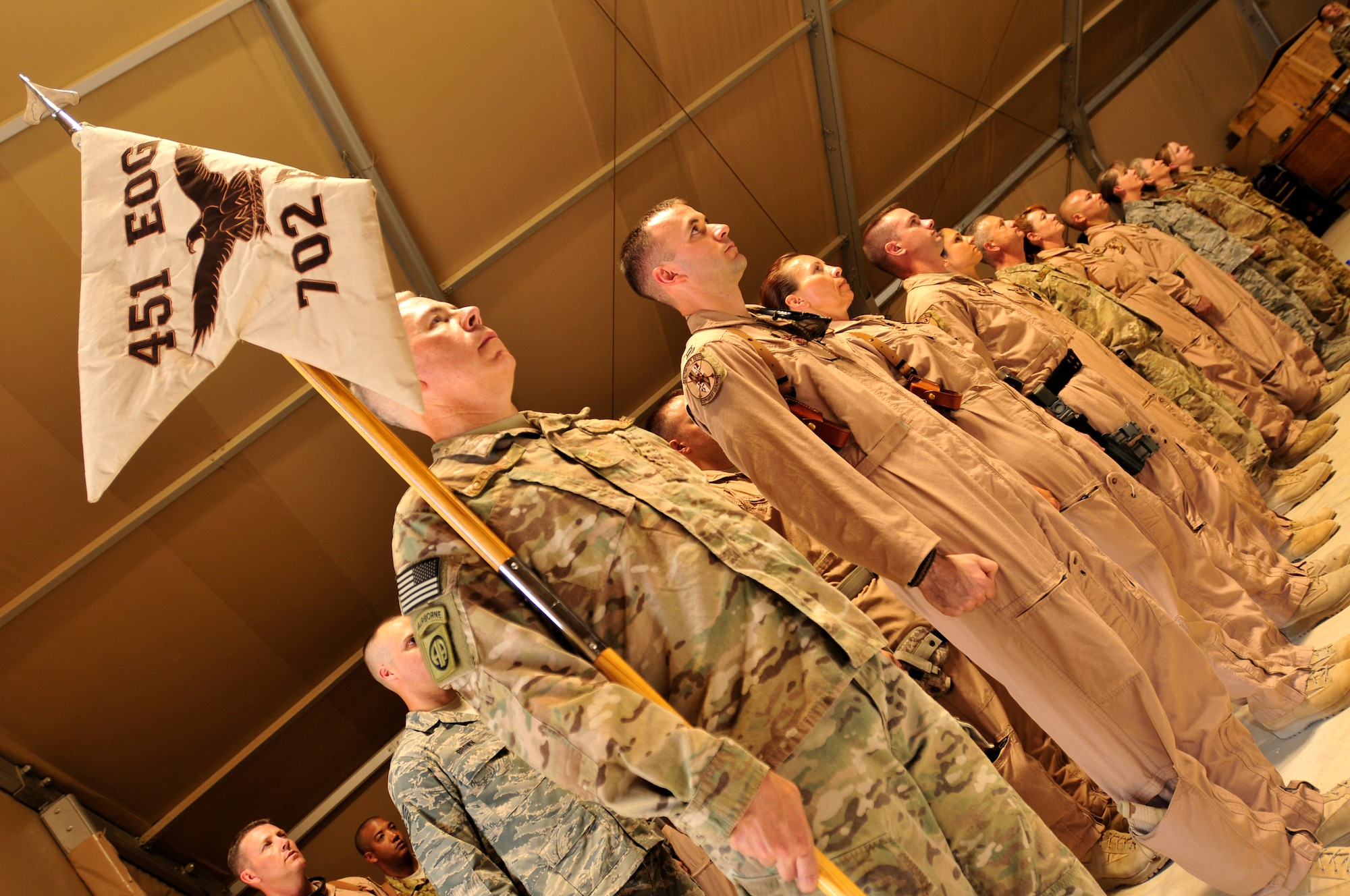 Aircrew and ground support personnel of the 702nd Expeditionary Airlift Squadron stand at attention while the official orders are published during their deactivation ceremony at Kandahar Airfield.  The squadron was established in July 2011 and was deactivated on Monday.  The squadron supported tactical airlift requirements in support of operations in Afghanistan (U.S. Army Photo - Sgt. Daniel J. Schroeder)